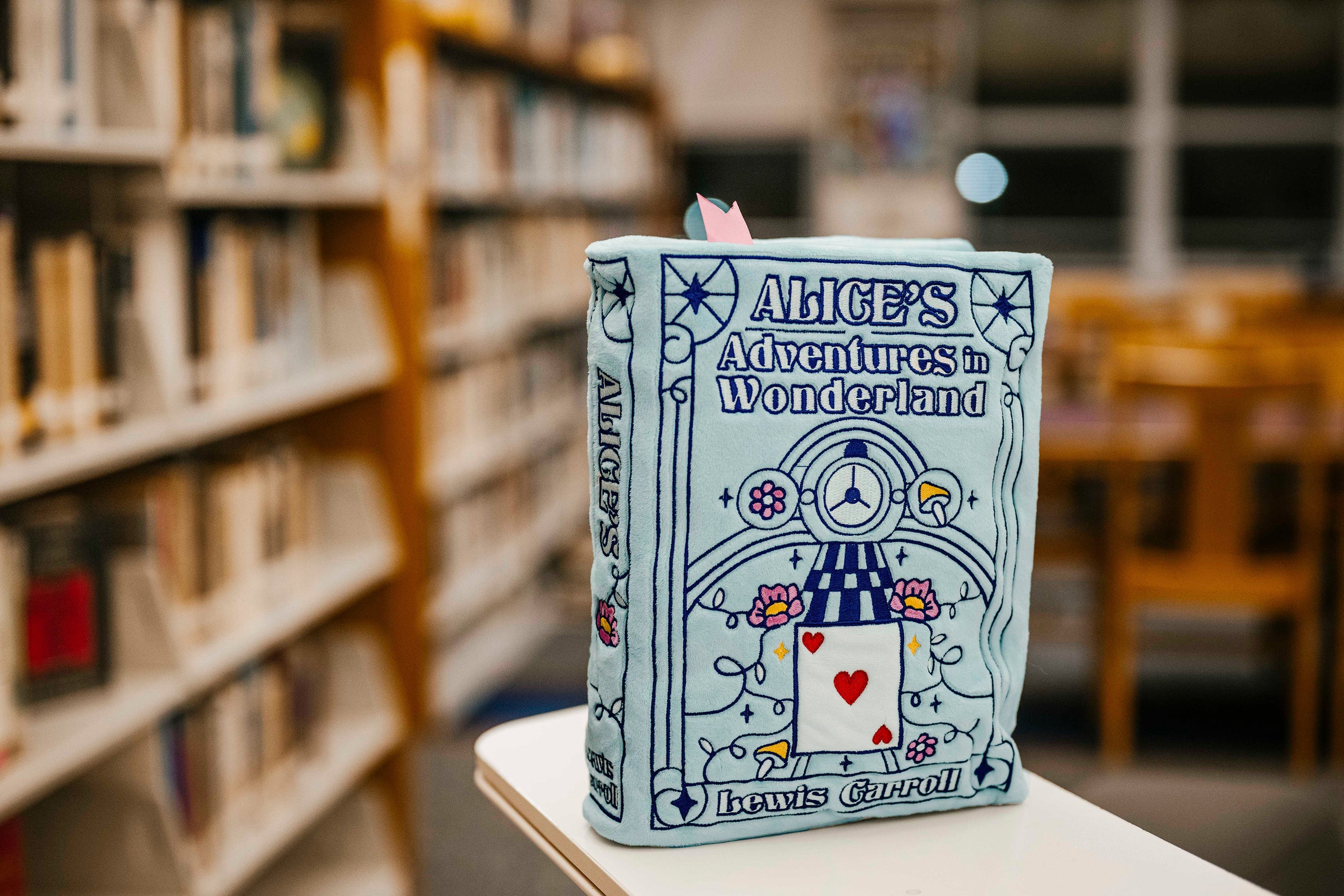 The Alice's Adventures in Wonderland book plush at the library
