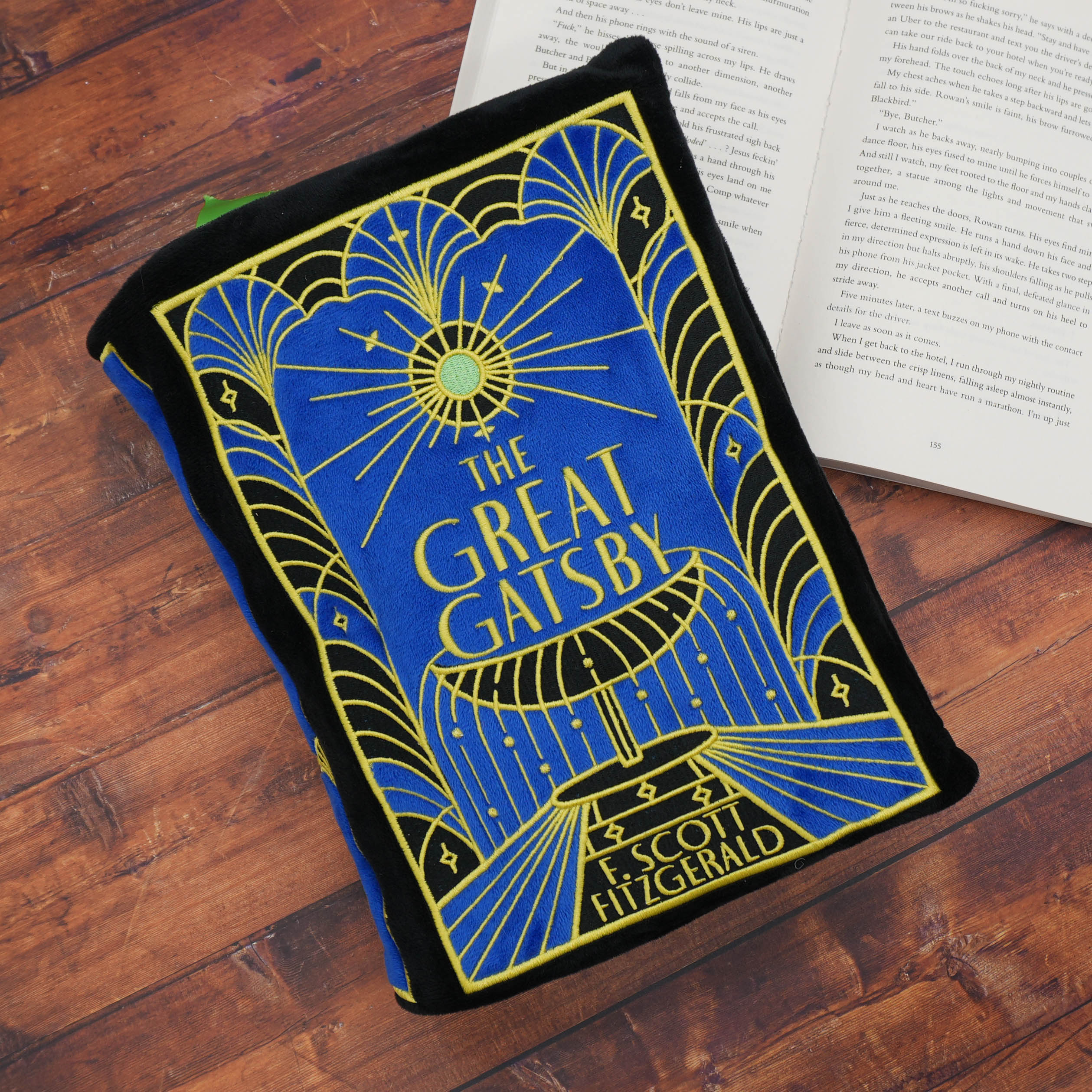 Plush book cover of 'The Great Gatsby' by F. Scott Fitzgerald on a wooden surface