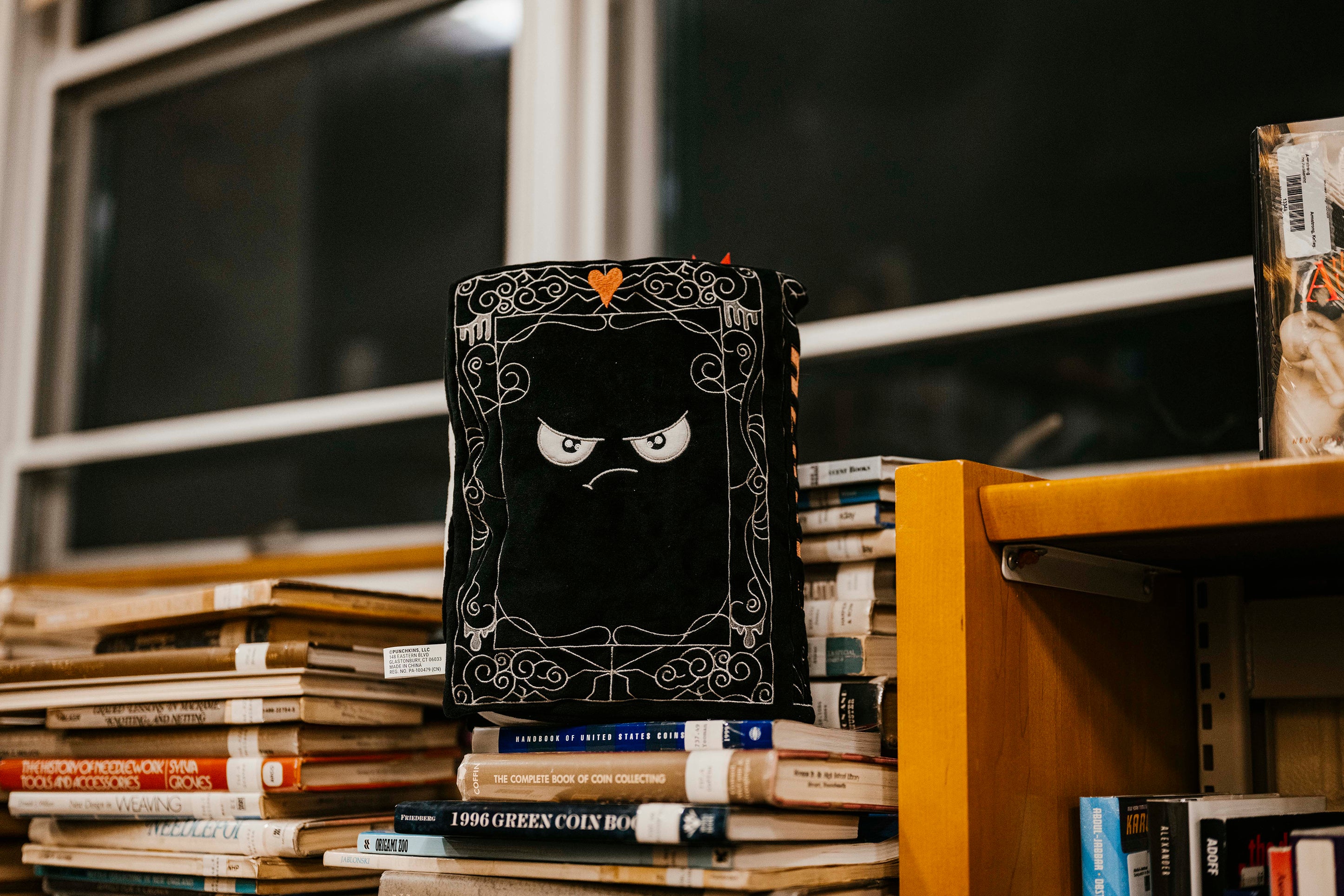The back cover of a decorative book plush of 'The Tell-Tale Heart' by Edgar Allan Poe.