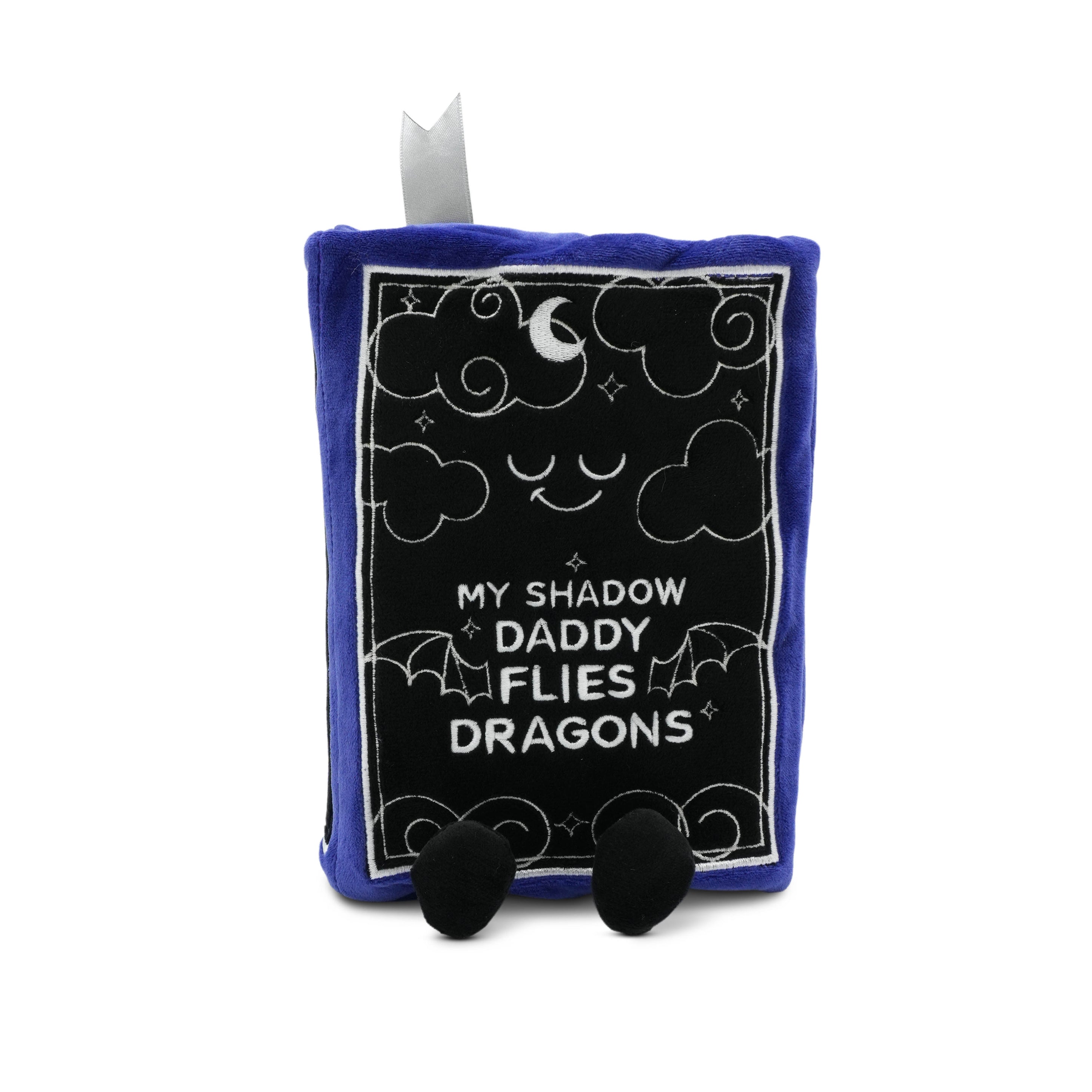 Plush book with 'my shadow daddy flies dragon' text on a white background
