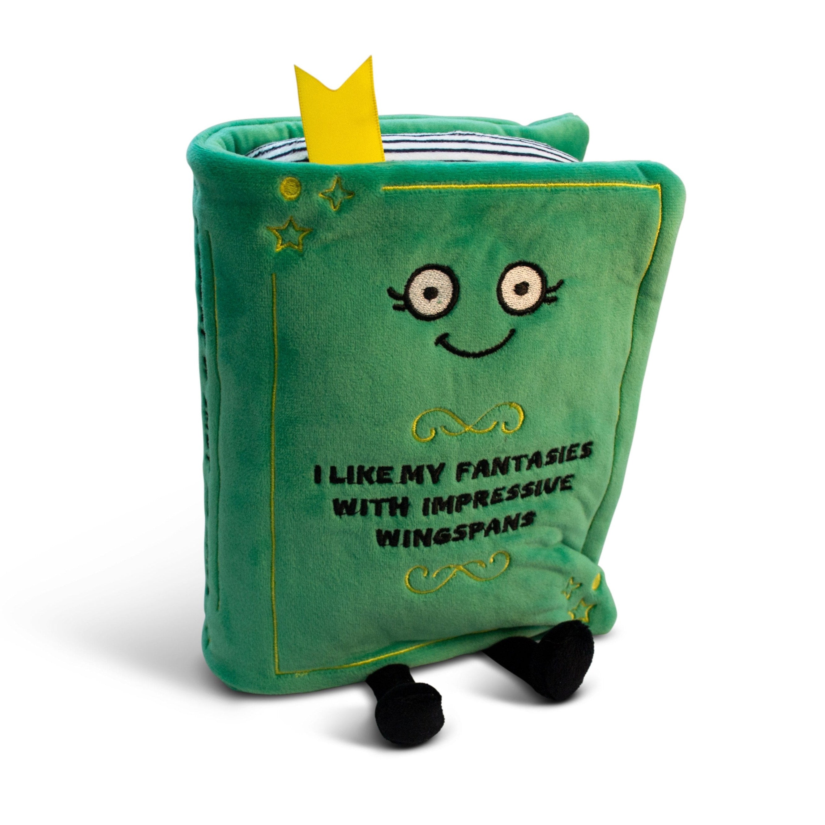 A plush designed to look like a green book with a smiling face and 'I like my fantasies with impressive wingspans' written on the cover.