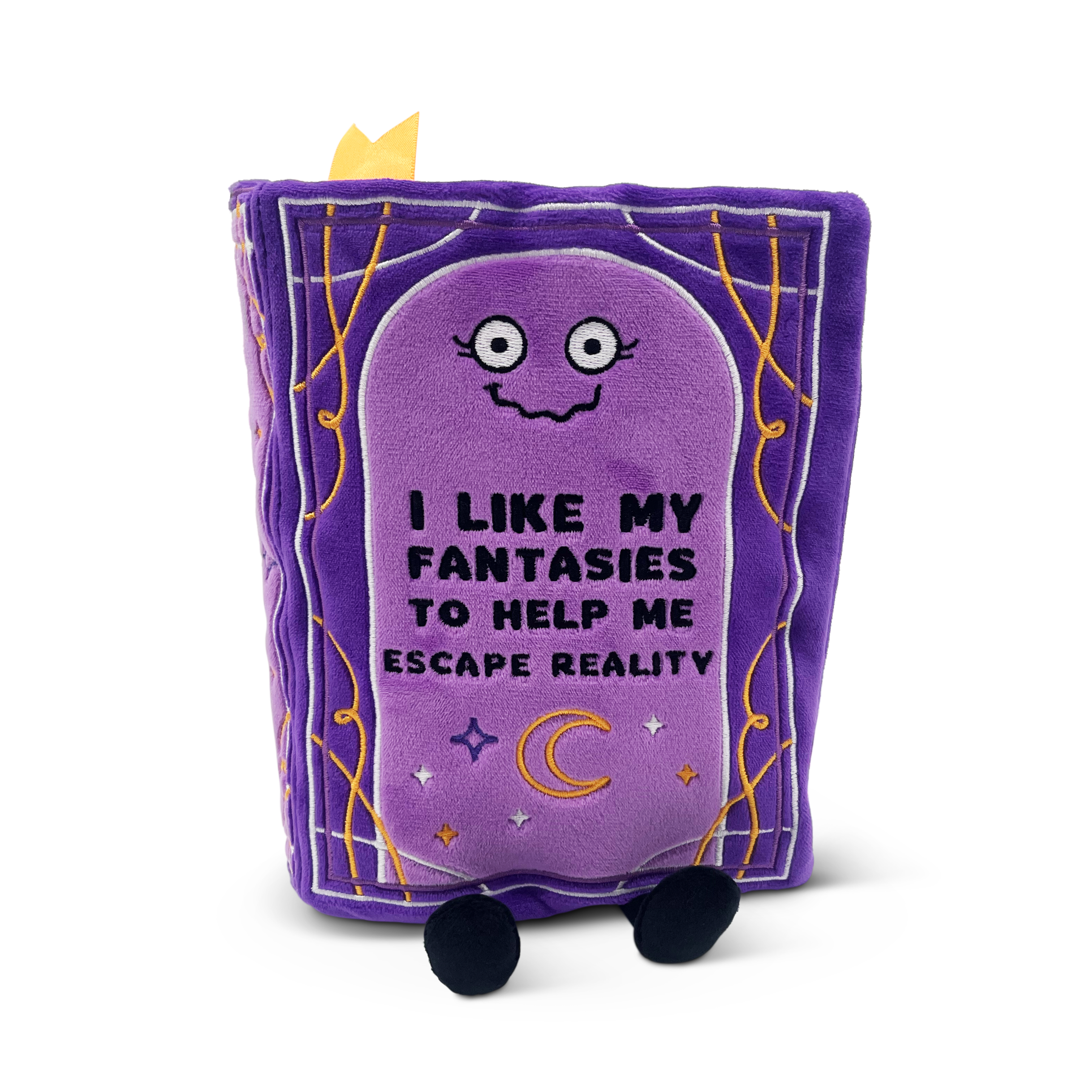 A plush book with the text 'I LIKE MY FANTASIES TO HELP ME ESCAPE REALITY' on the front cover.