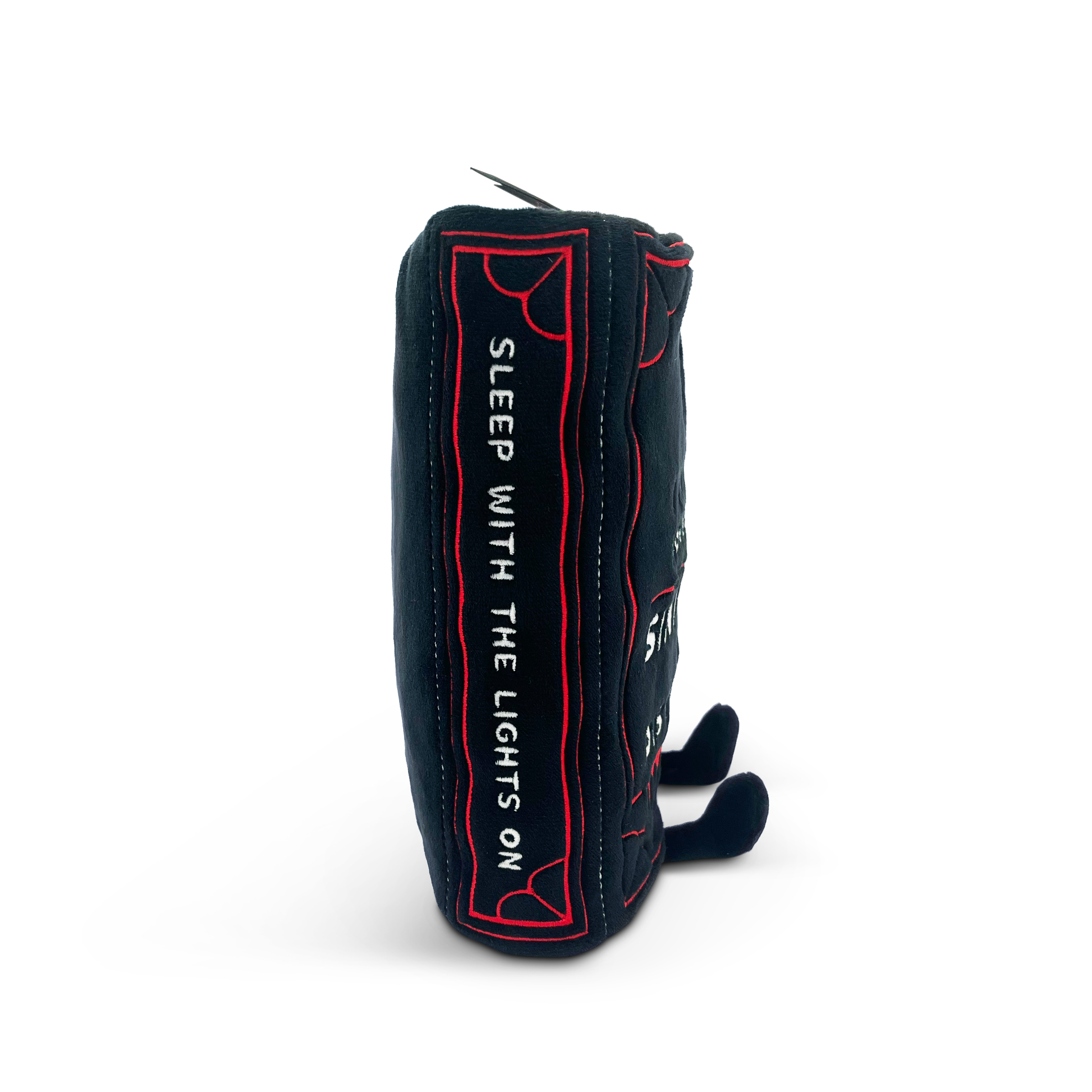 Book plush with 'sleep with the lights on' embroidered on the spine.