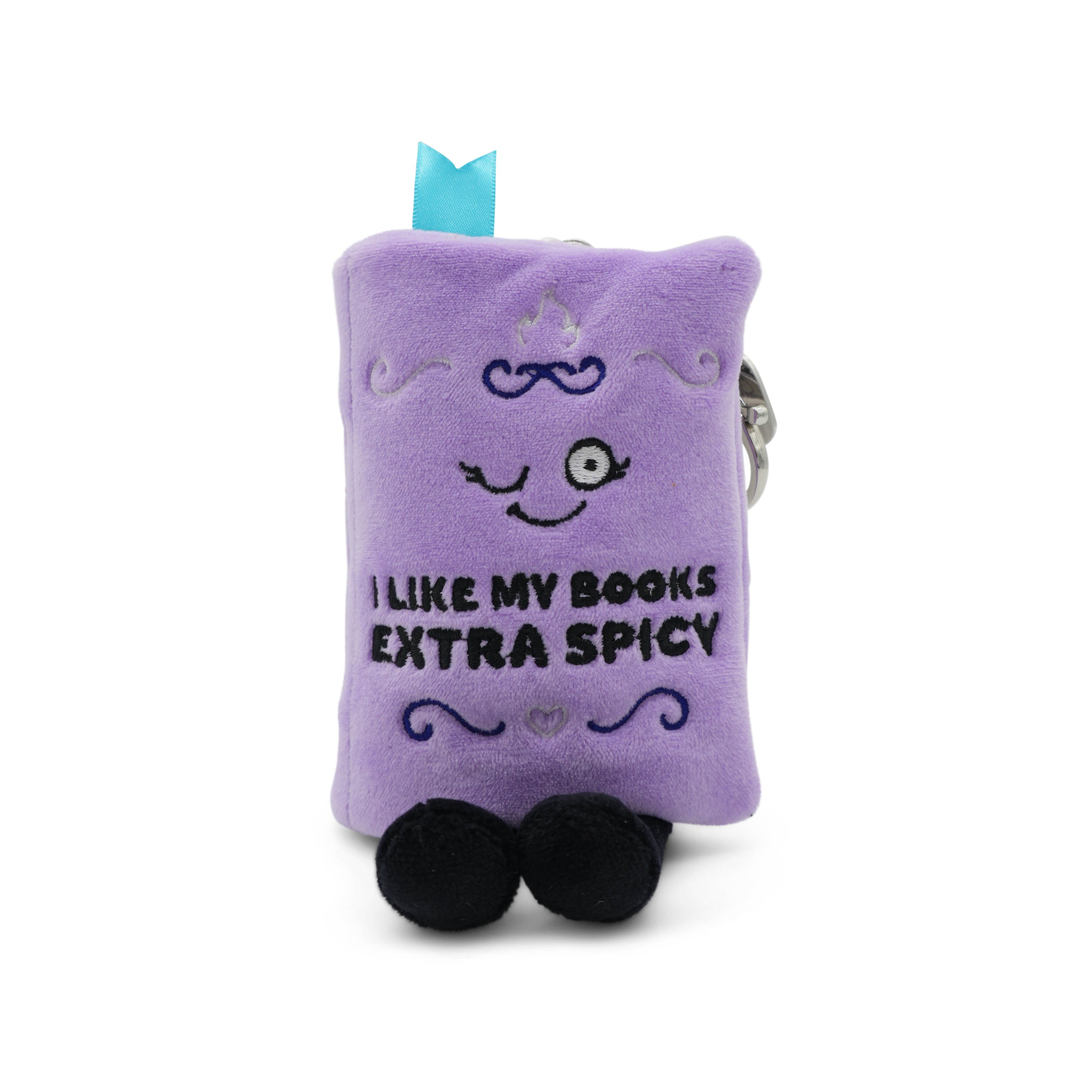 Purple book plush bag charm with 'I like my books extra spicy' text taken on a white background