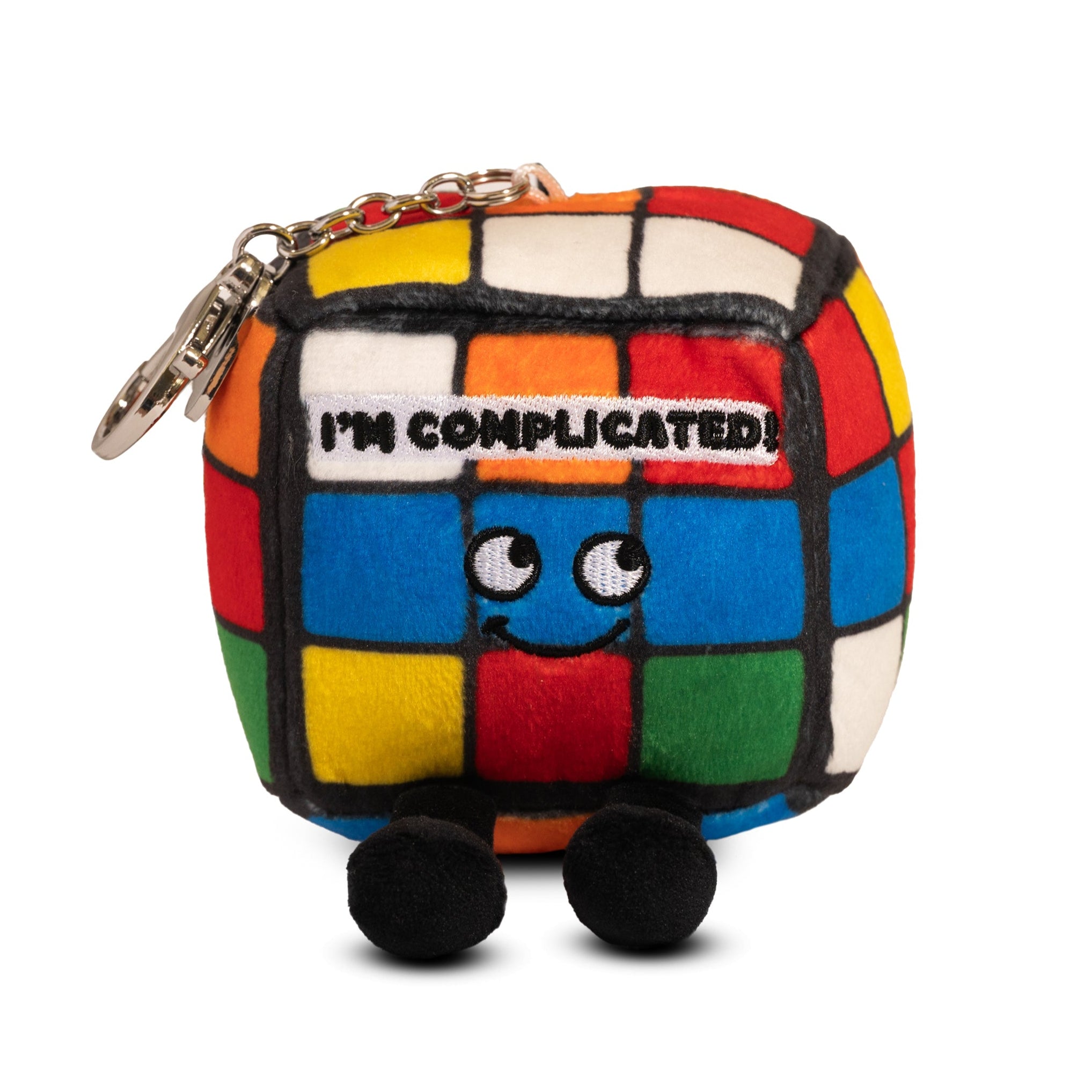 A colorful cube-shaped plush bag charm with character features and the text 'I'M COMPLICATED!' on the front.