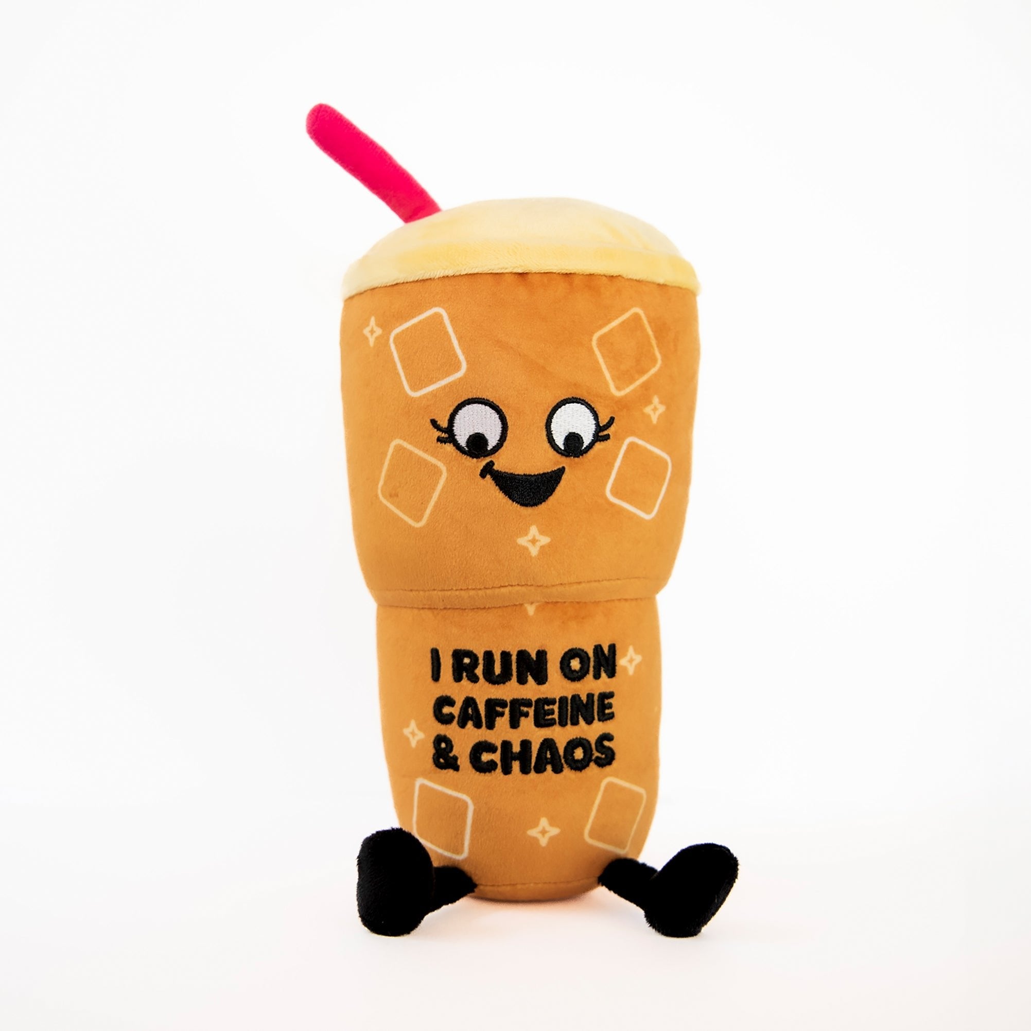 A plush designed to look like an iced coffee cup with a character face, text 'I RUN ON CAFFEINE & CHAOS', and accessories like a straw and ice cubes.