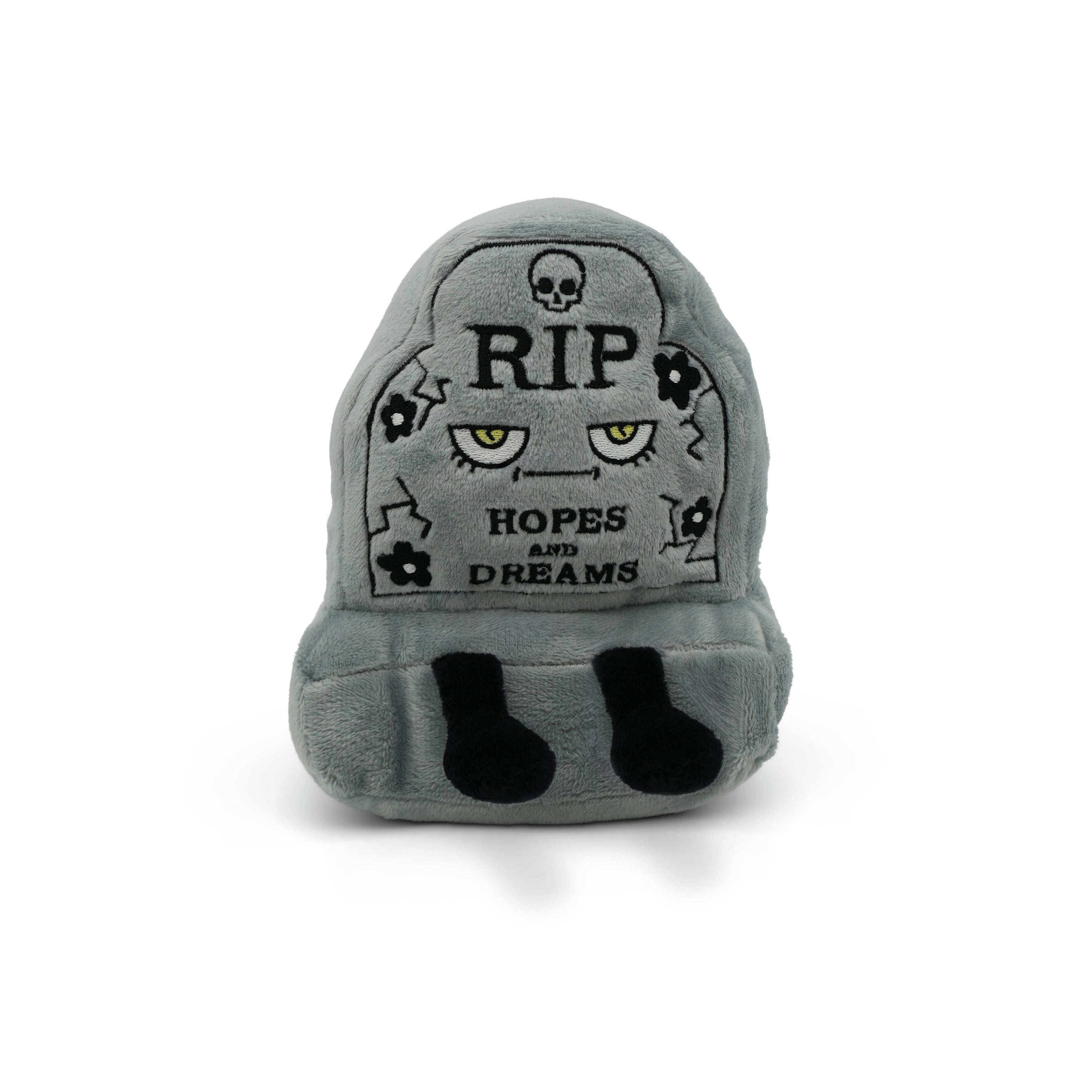 Gray plush toy shaped like a headstone with text and skull designs on a white background.