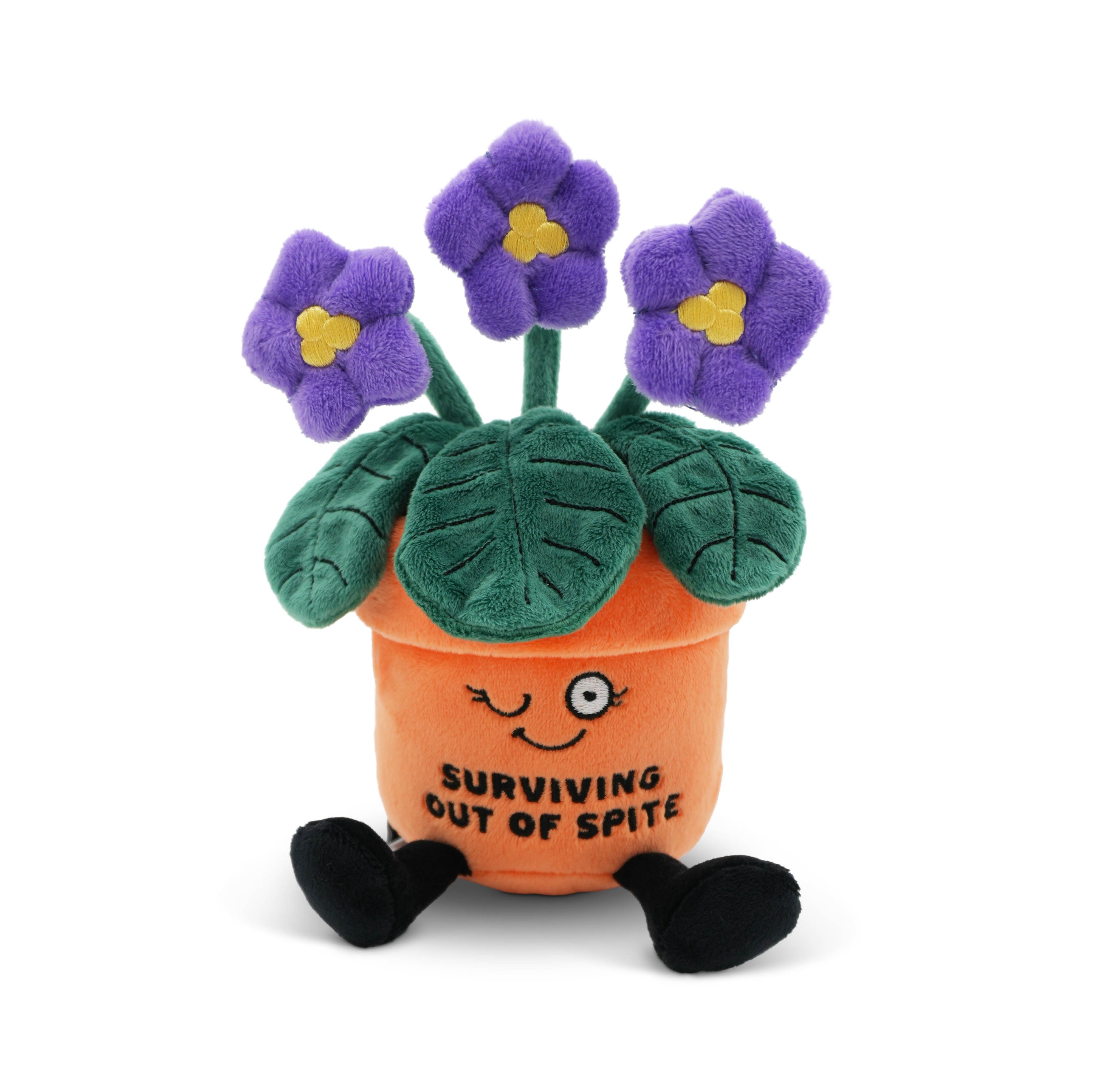 Plush potted plant with purple flowers and a smiling face with the text "surviving out of spite" on a white background.