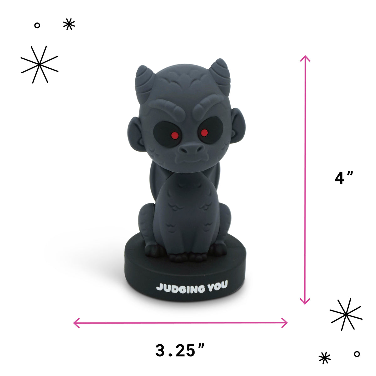 A small dark gray seated gargoyle figurine with red eyes on a black round base labeled 'JUDGING YOU,' shown with pink dimension arrows and text indicating 4 inches tall by 3.25 inches wide on a white background.