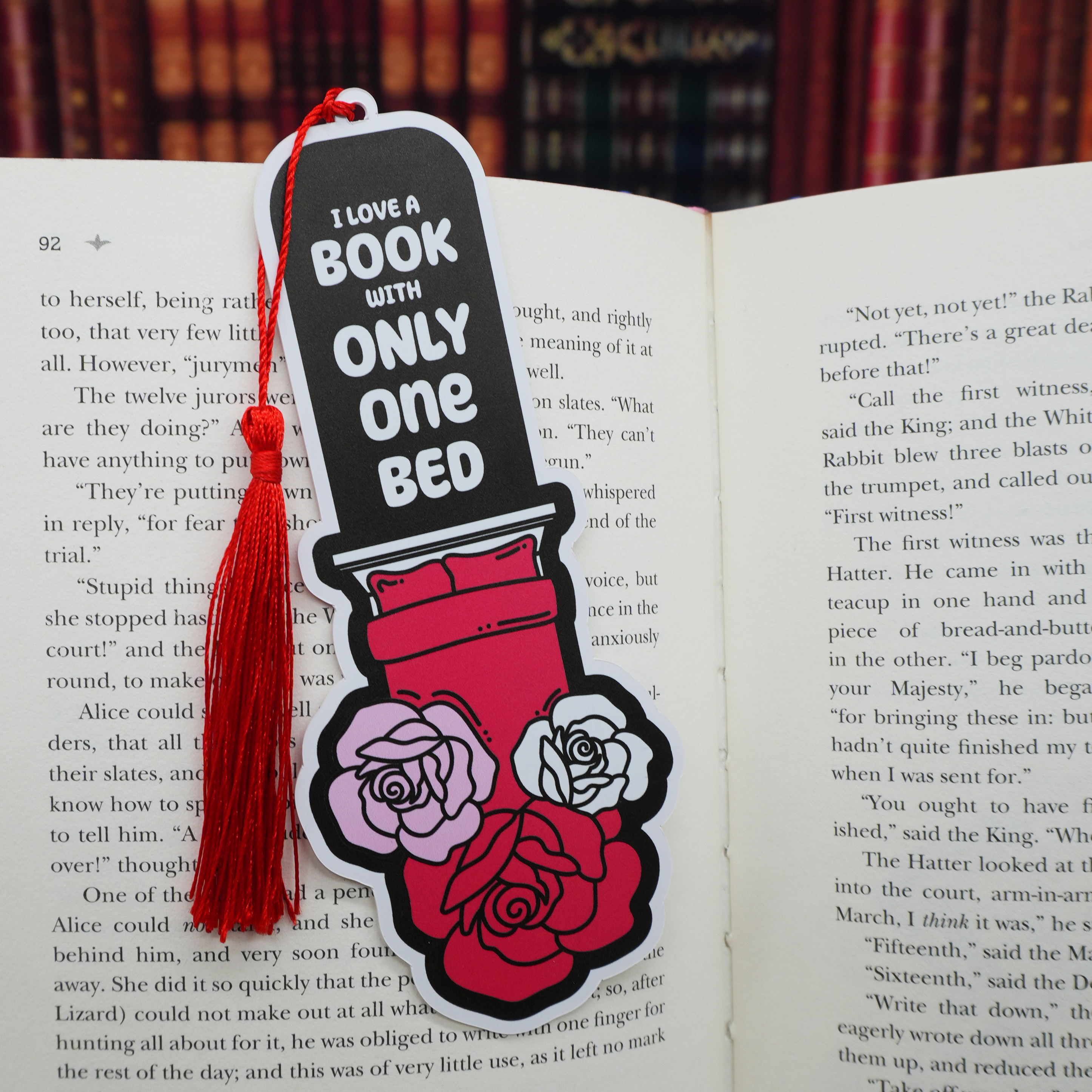 Bookmark with 'I love a book with only one bed' text on an open book