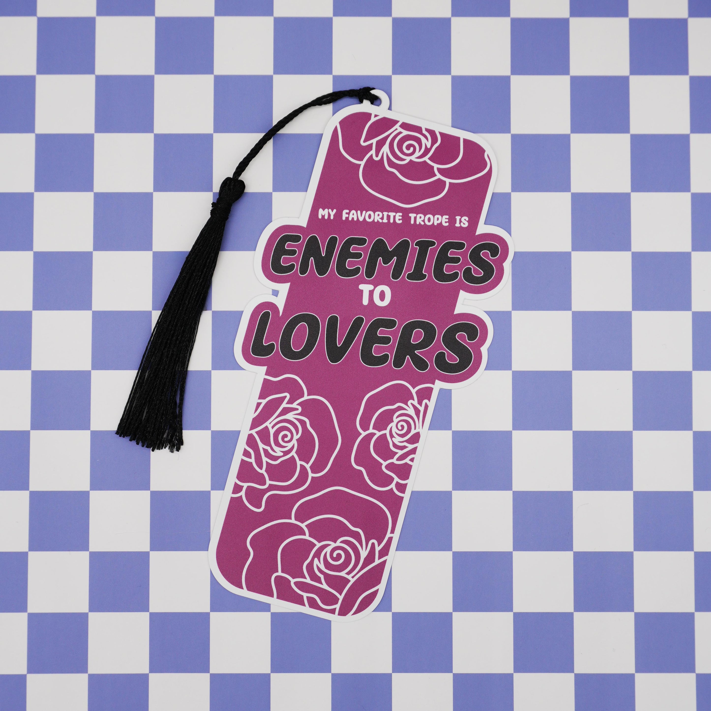 Decorative bookmark with roses and 'enemies to lovers' text on a checkered background