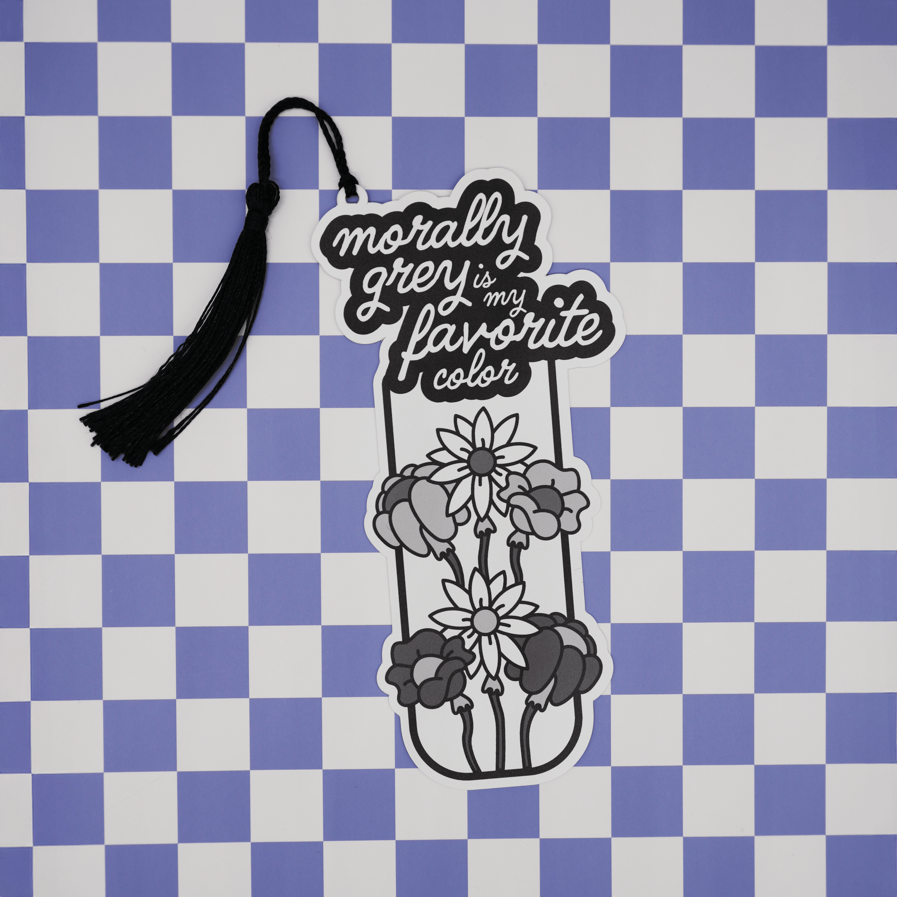Decorative bookmark with floral design and text on a checkered background