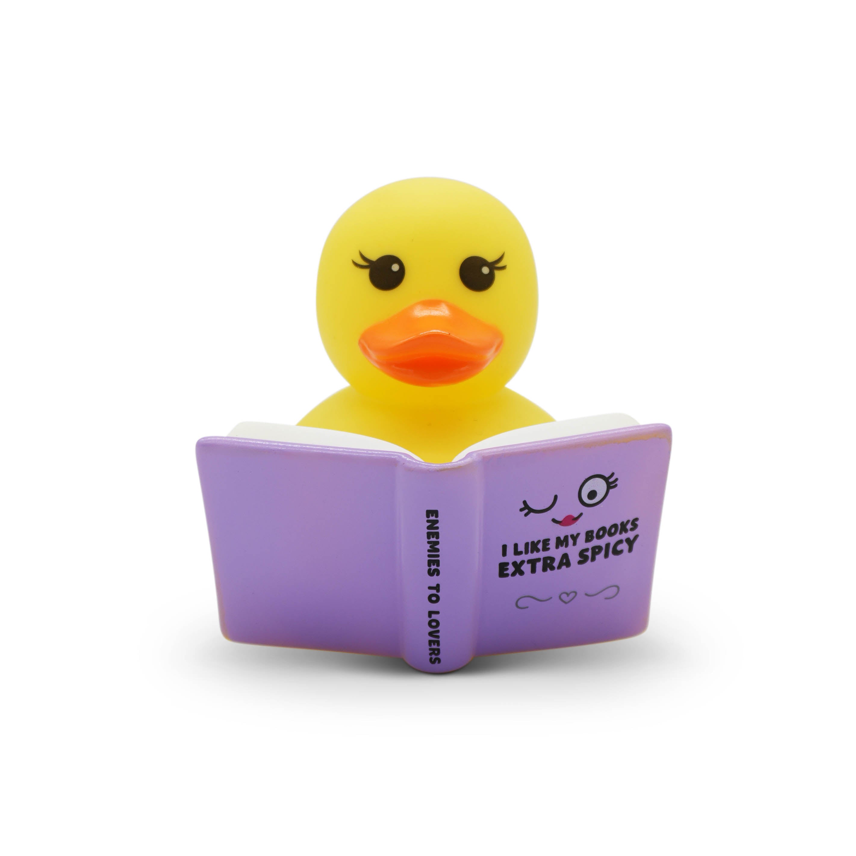 Yellow rubber duck reading a spicy romance book on a white background