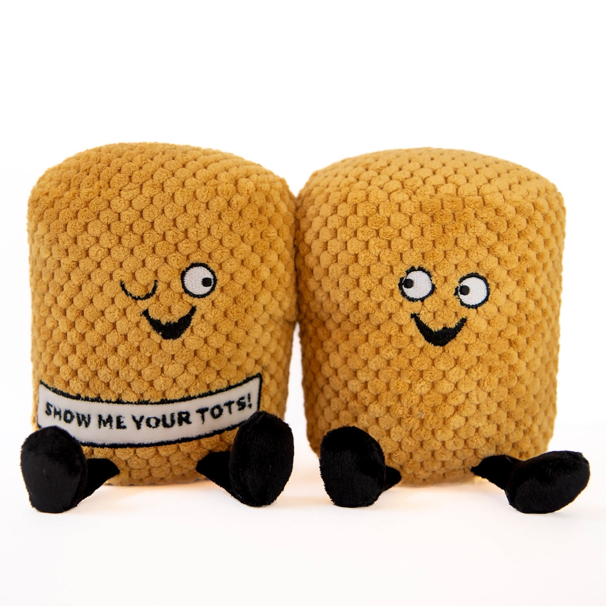 A plushie designed to resemble a pair of tater tots with faces and text that reads 'SHOW ME YOUR TOTS!'