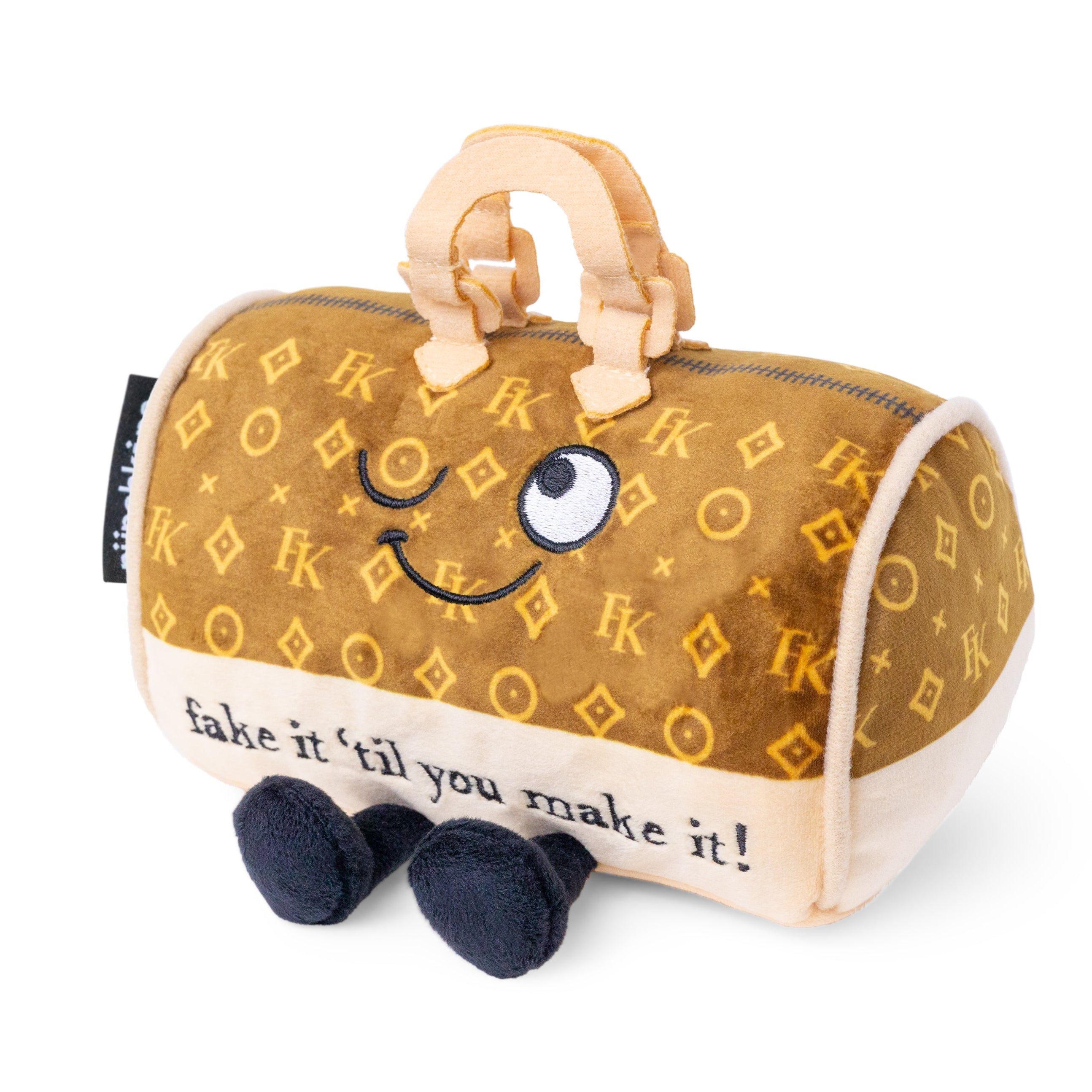 A plush handbag with a smiling face and the phrase 'fake it 'til you make it!' printed on it.