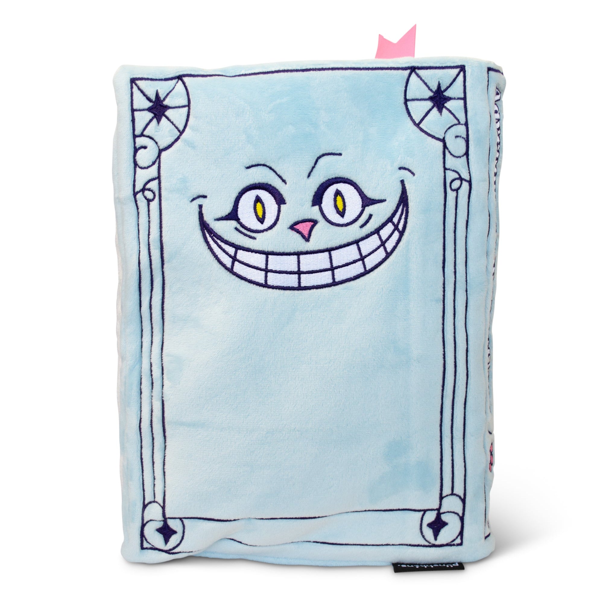 The back cover of the plush book shows the embroidered cartoon face of the Cheshire Cat.