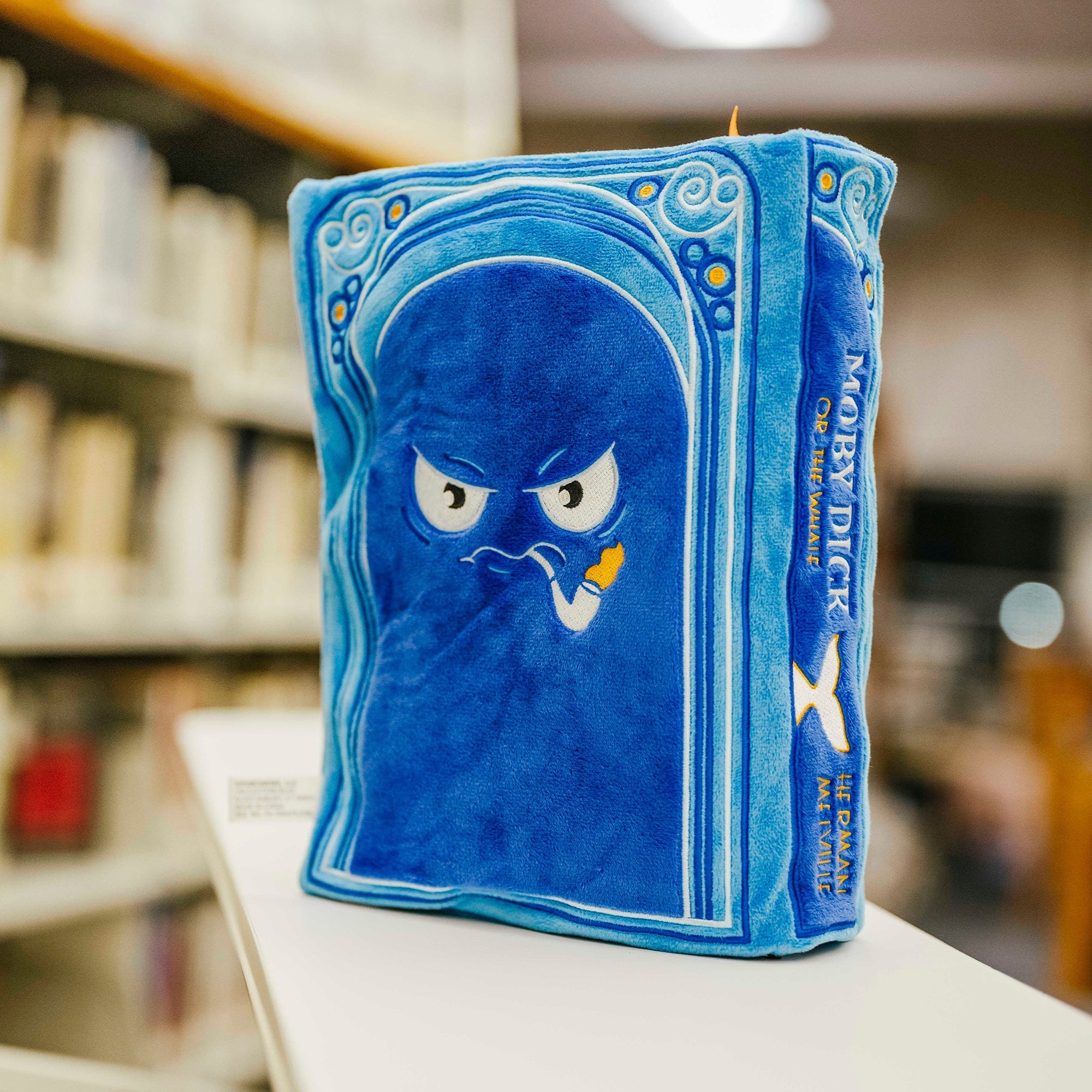 Back cover of the Moby Dick book plushie, featuring a cartoon face of the captain 