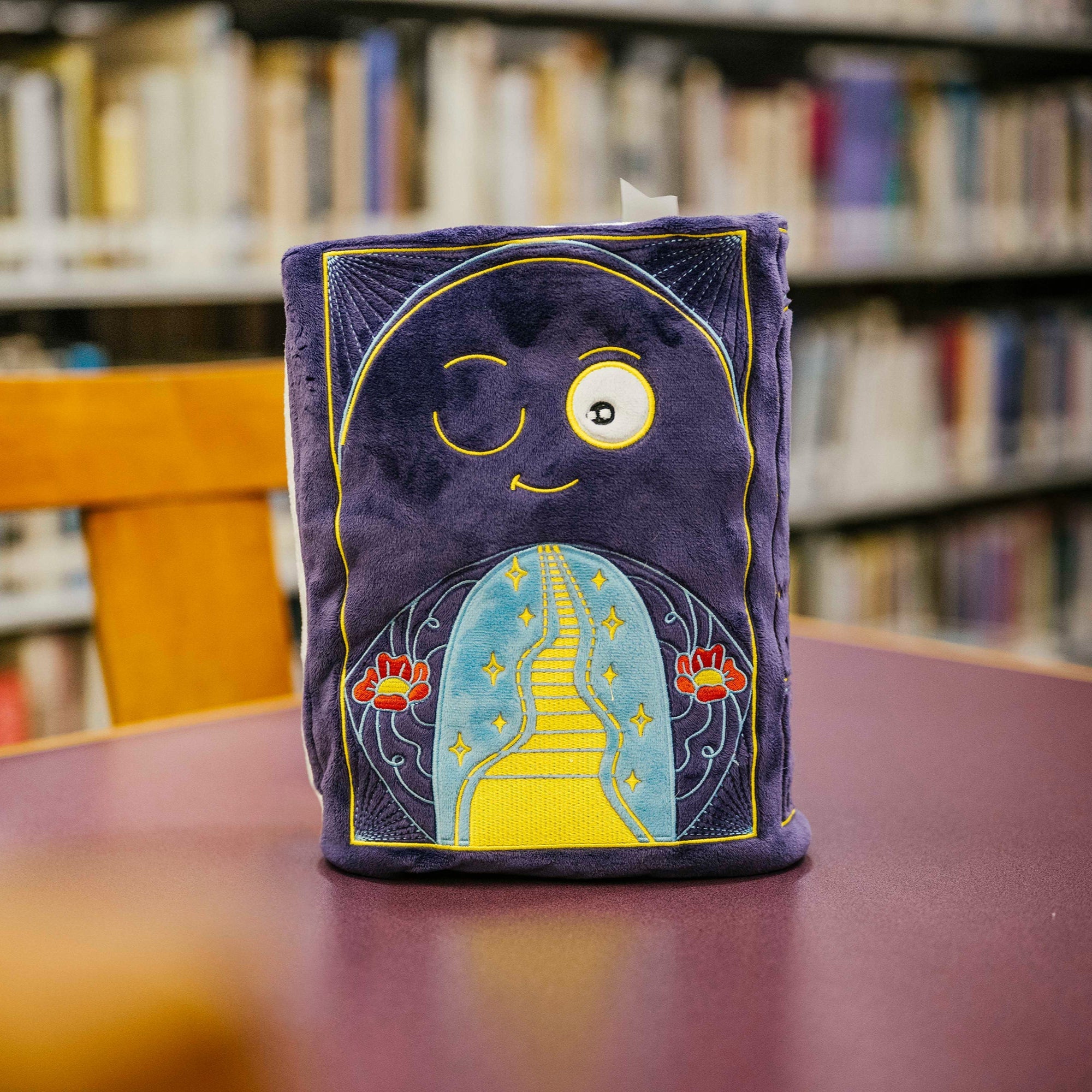 Back of book plushie shows a walk down the yellow bick road through poppies 