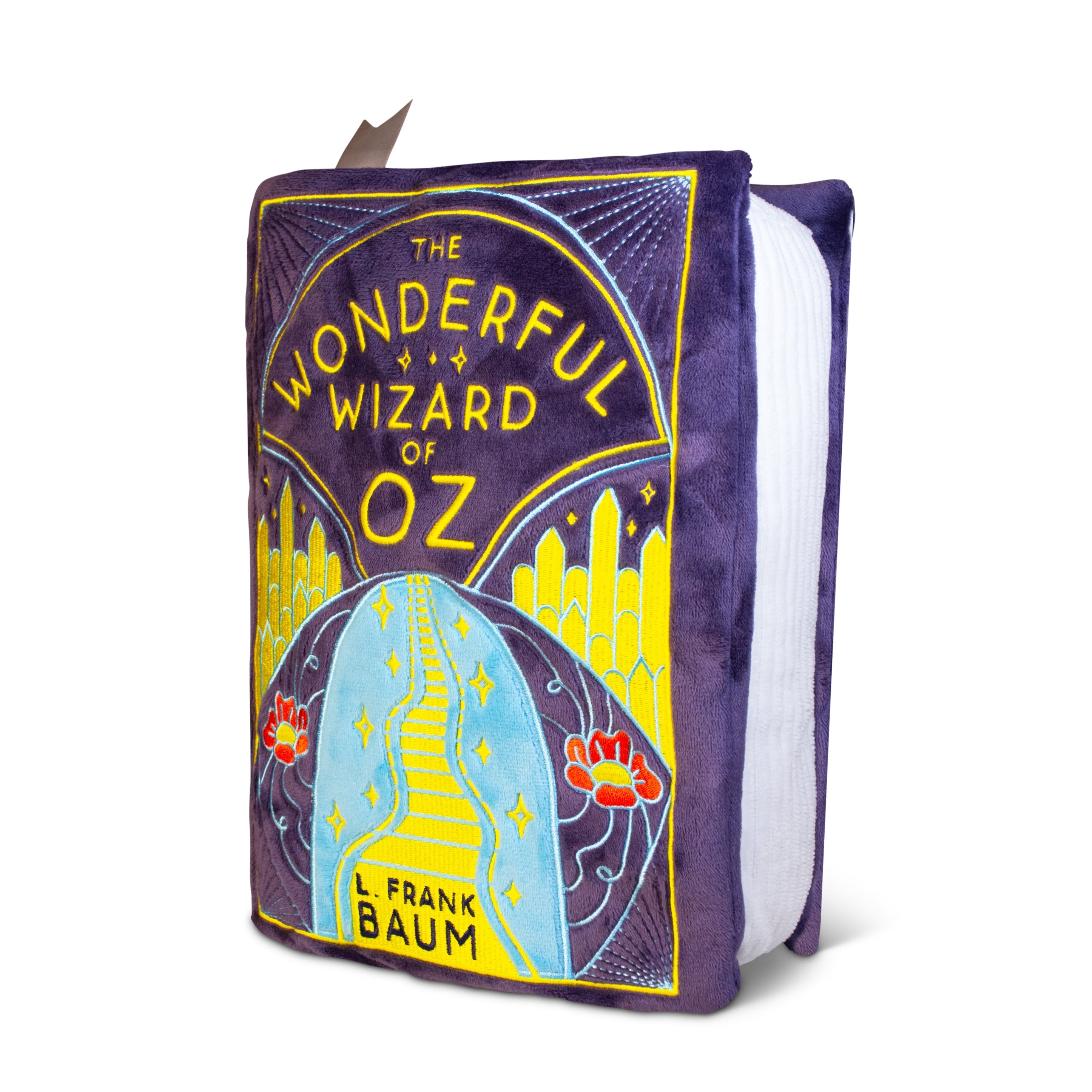 Plushie designed to look like the book 'The Wonderful Wizard of Oz.' The cover features an embroidered scene of a walk down the Yellow Brick Road.