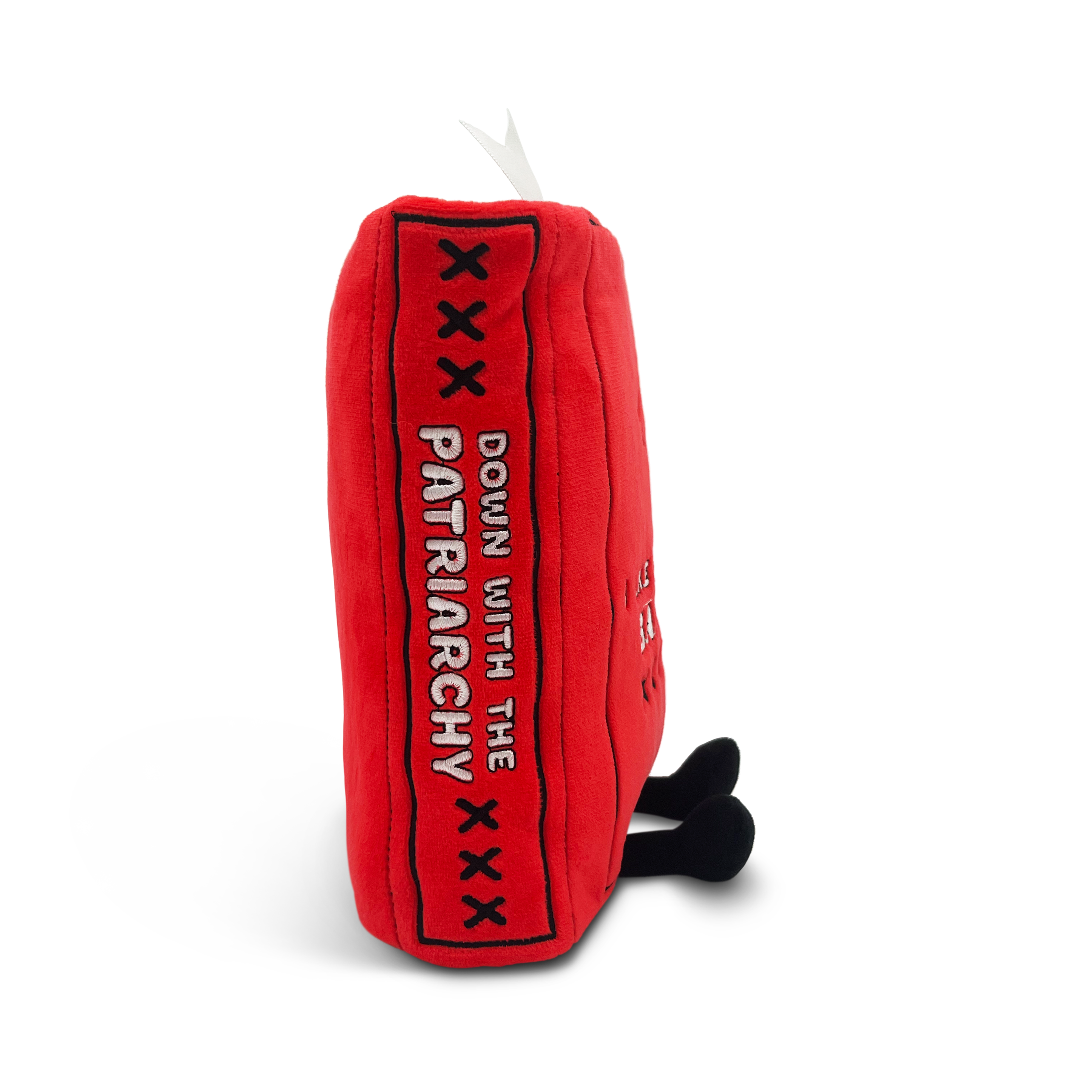 A red plush book with the text 'Down with the patriarchy' on the spine.