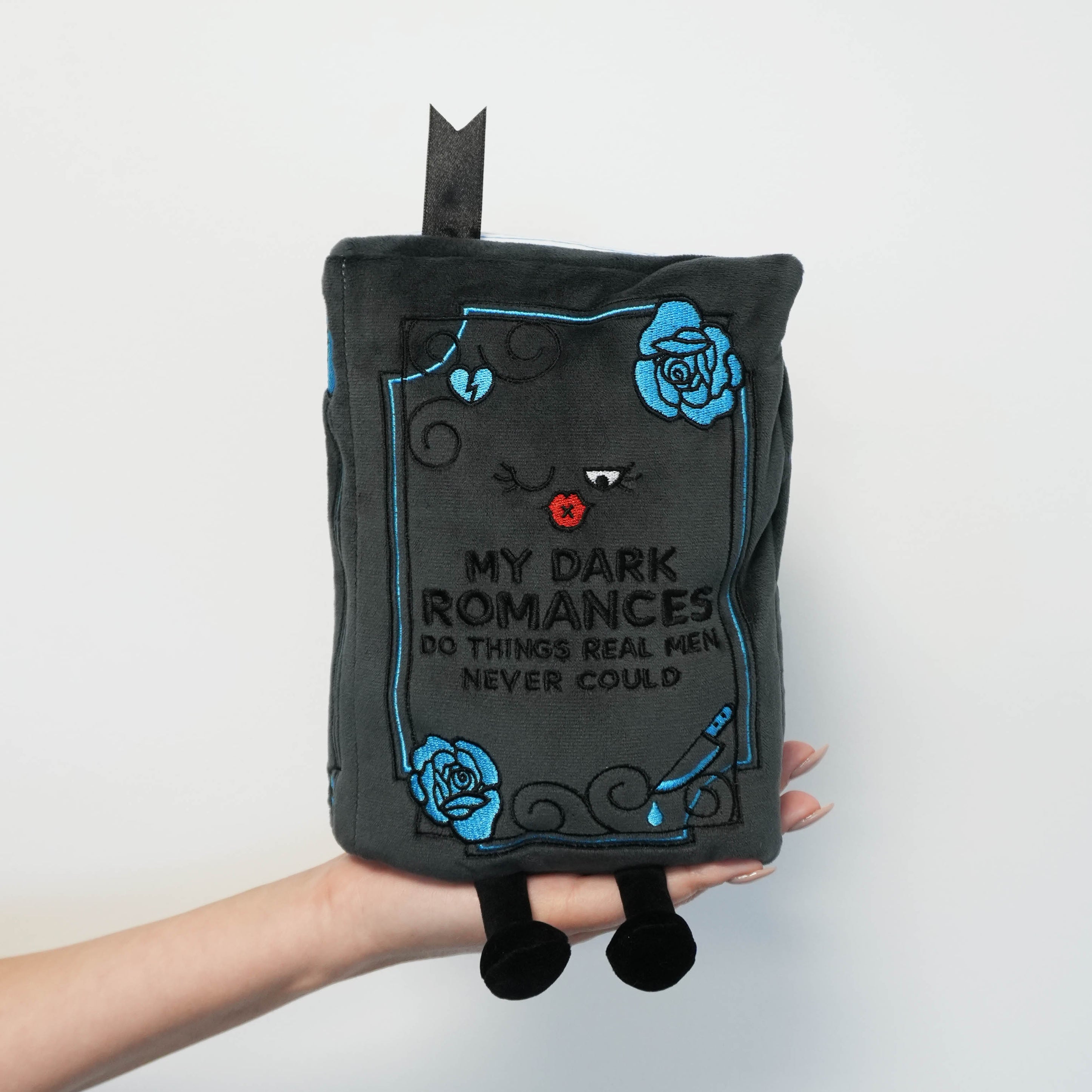Plush shaped like a book with text and roses on a white background