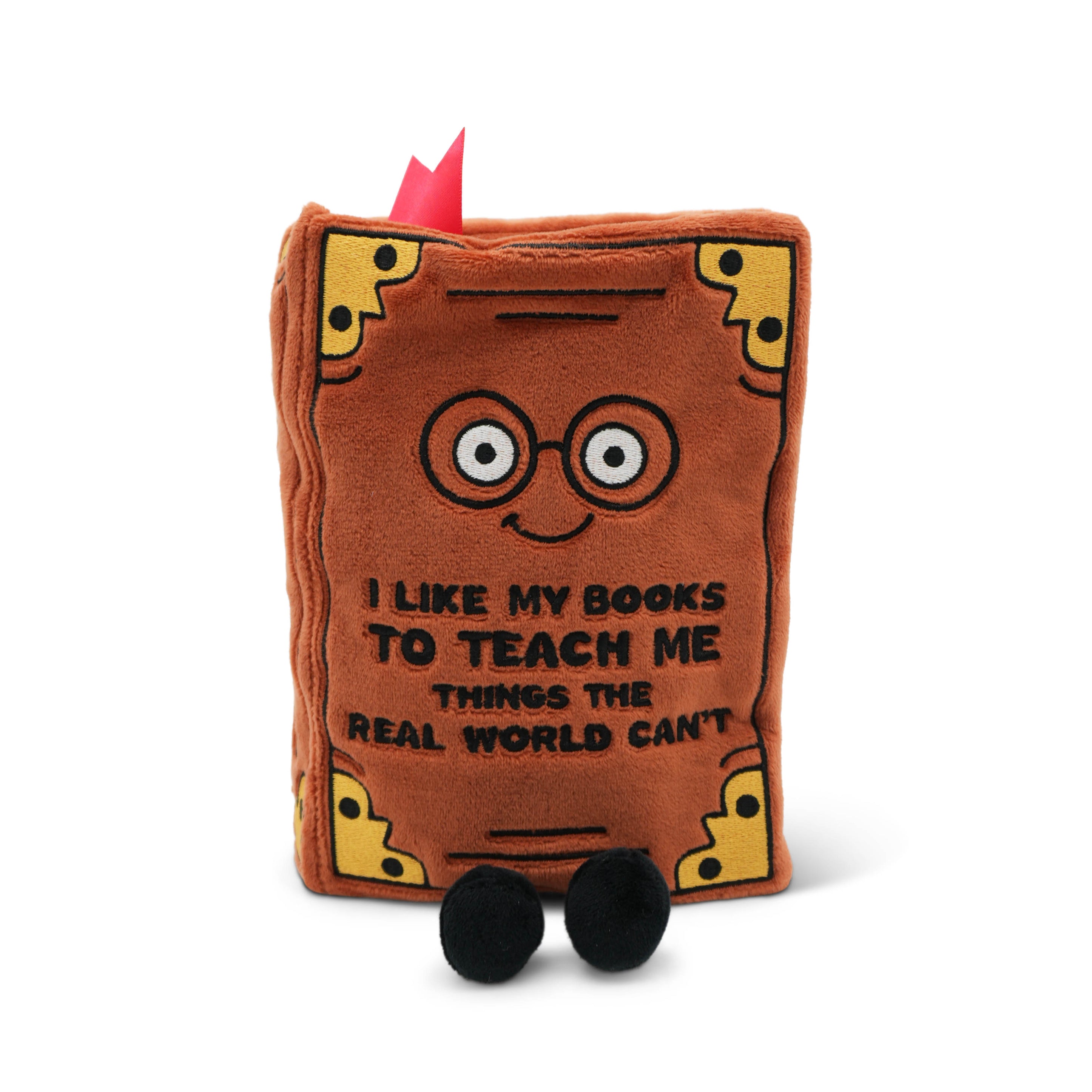 Plush book that reads "I like my books to teach me things the real world can't" on a white background