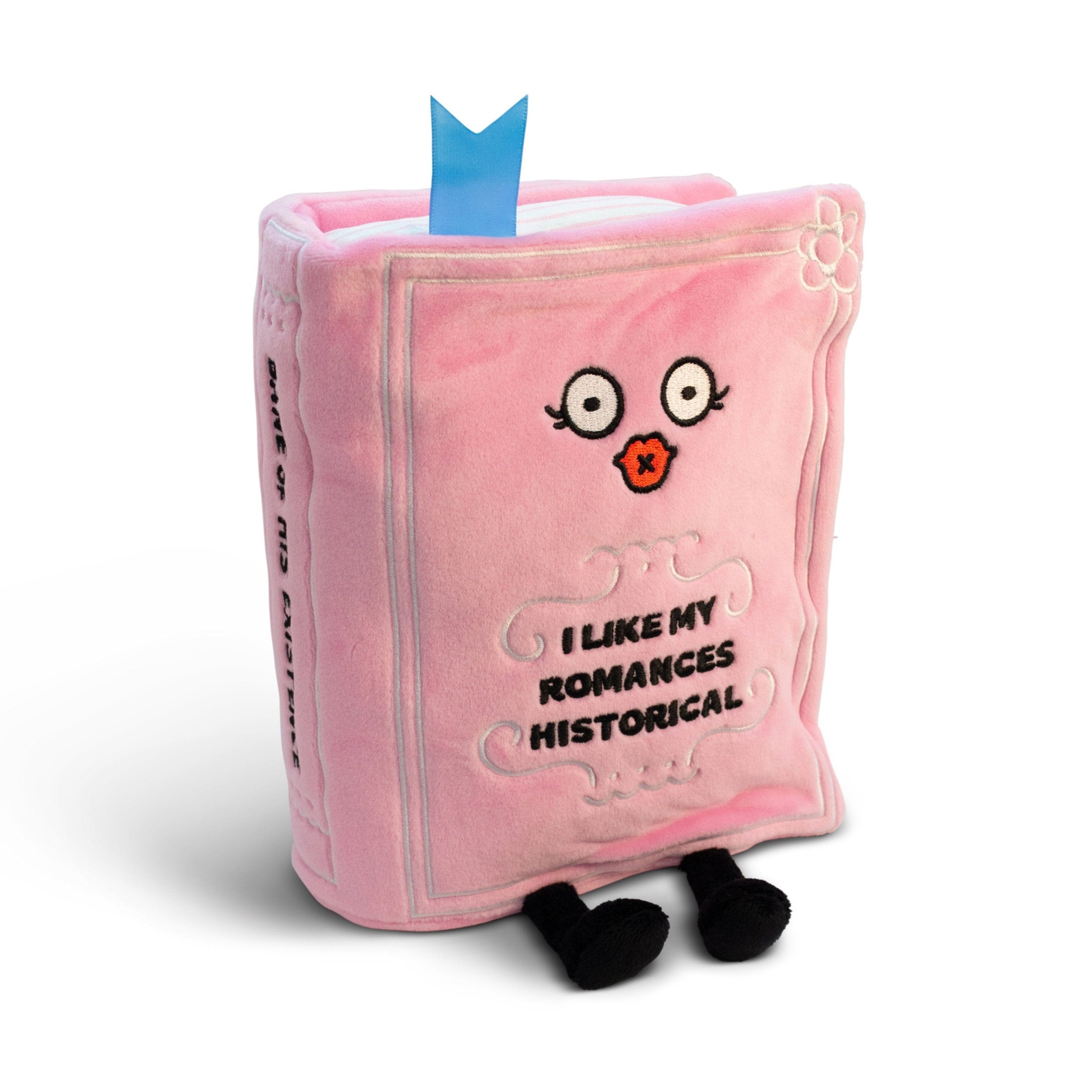 A pink plush designed to look like a book with a face, dangly legs, and text that reads, 'I like my romances historical'.