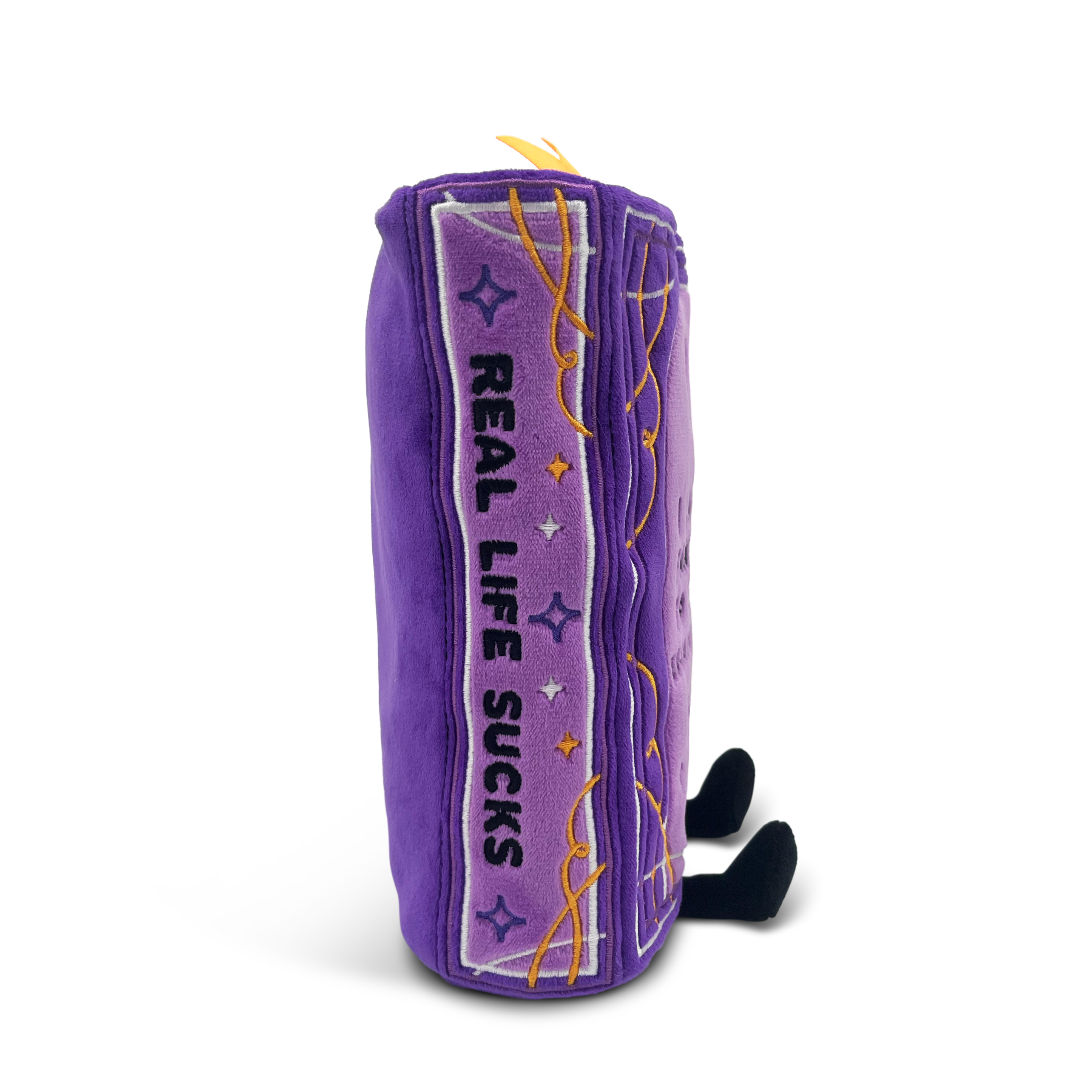 Plush fantasy book with 'Real Life Sucks' embroidered on the spine.