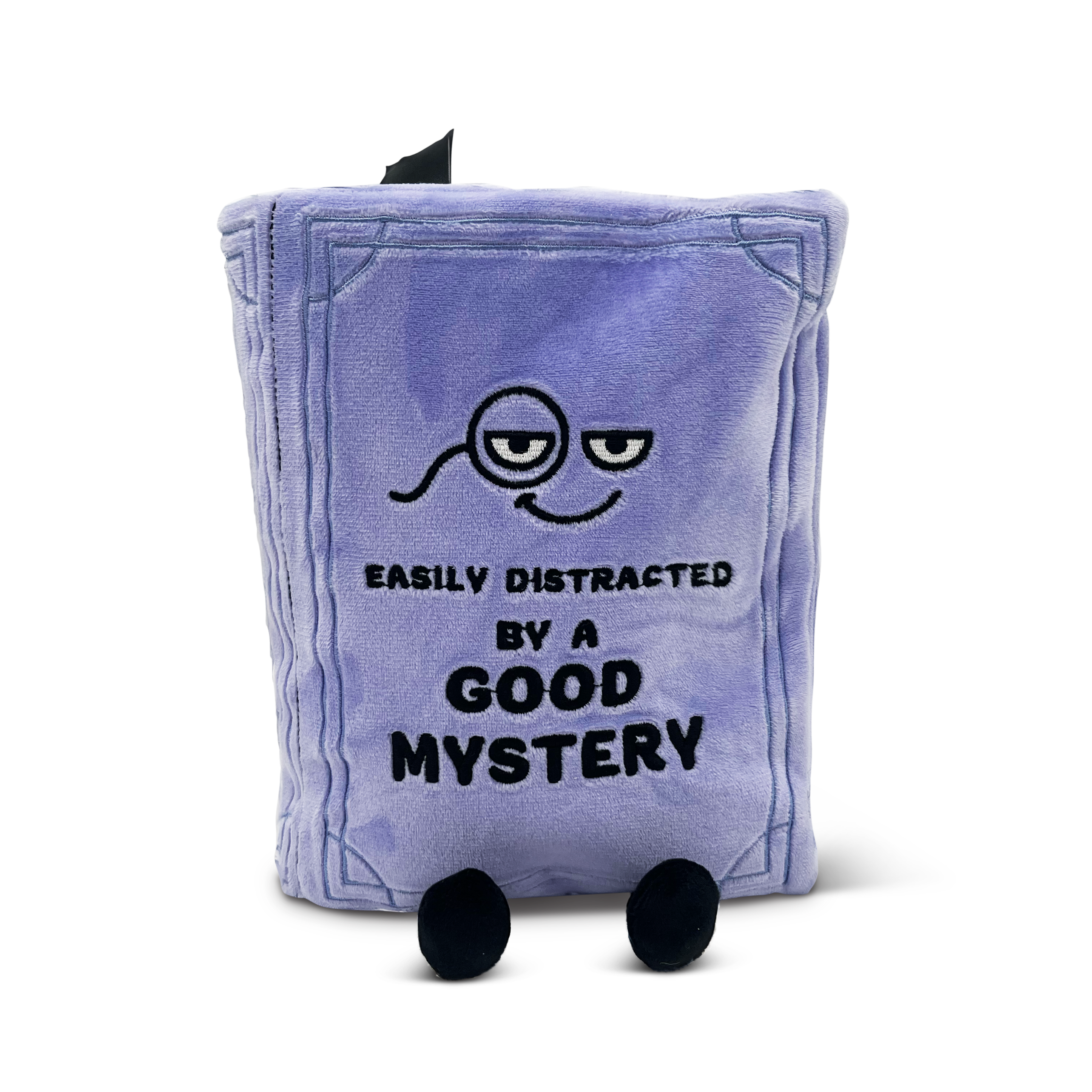 A plush book with the title 'EASILY DISTRACTED BY A GOOD MYSTERY' on the cover, with a character illustration on the front and dangly legs.