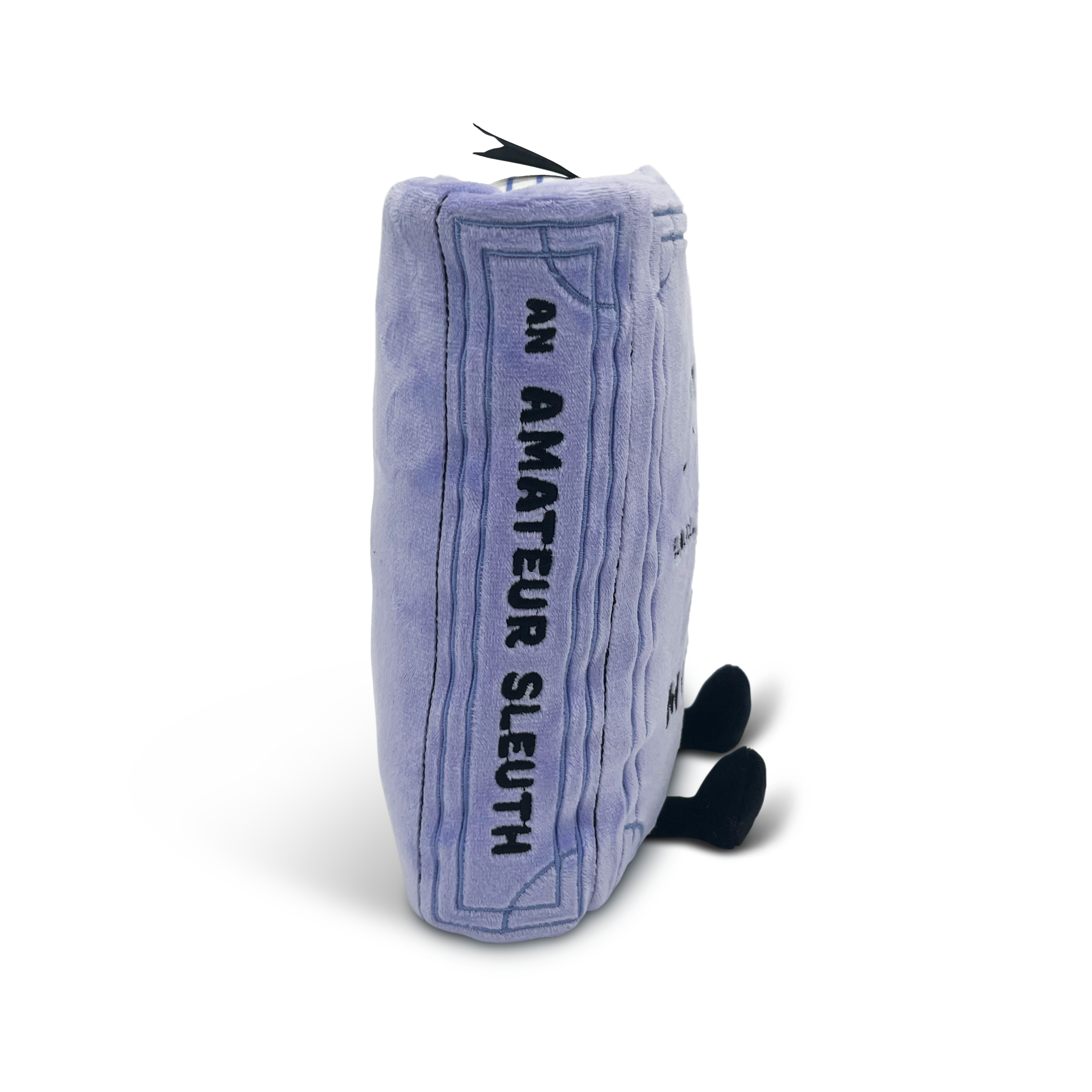 Mystery book plush with 'an amateur sleuth' embroidered on the spine.