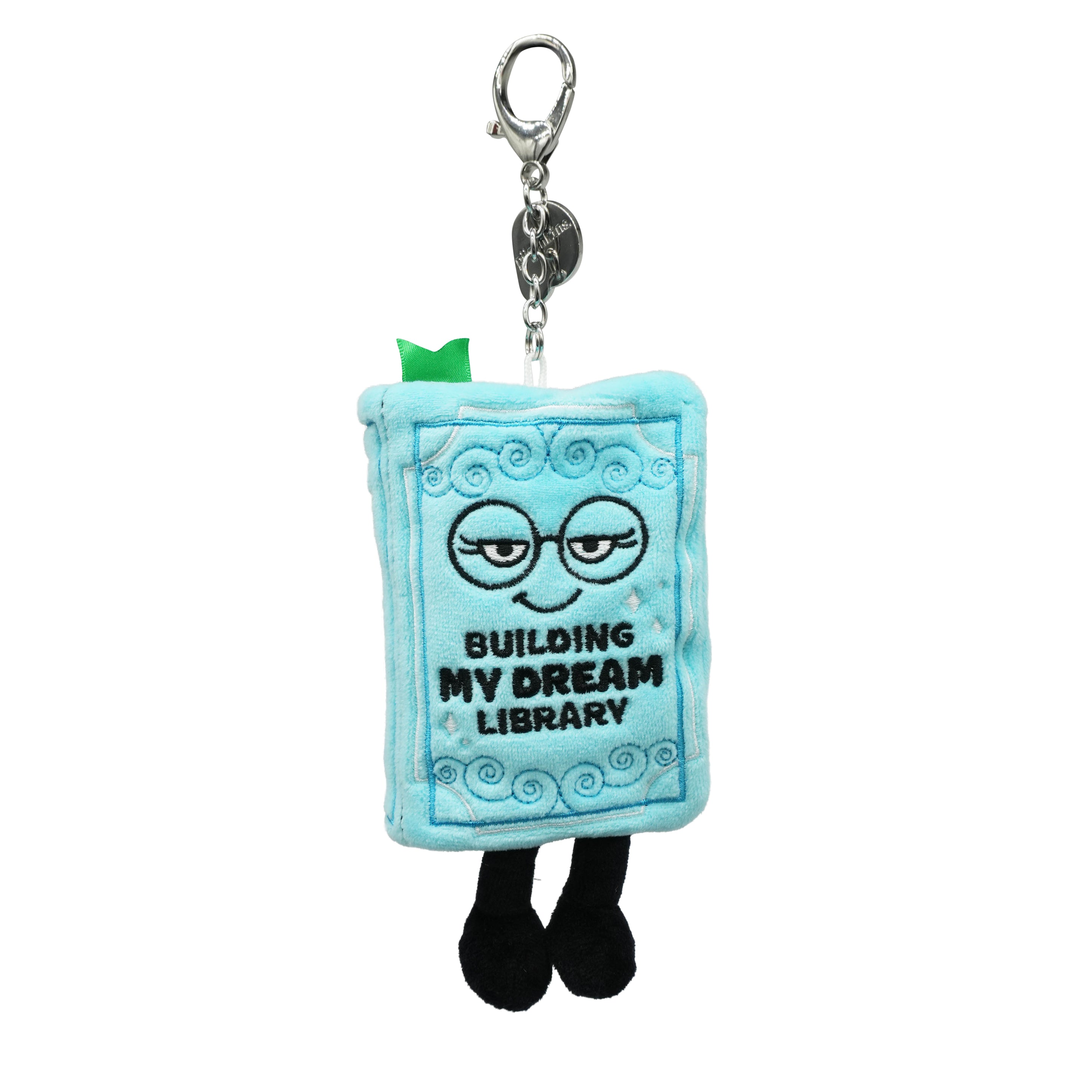 Blue plush bag charm with a book design and 'Building My Dream Library' text on a white background