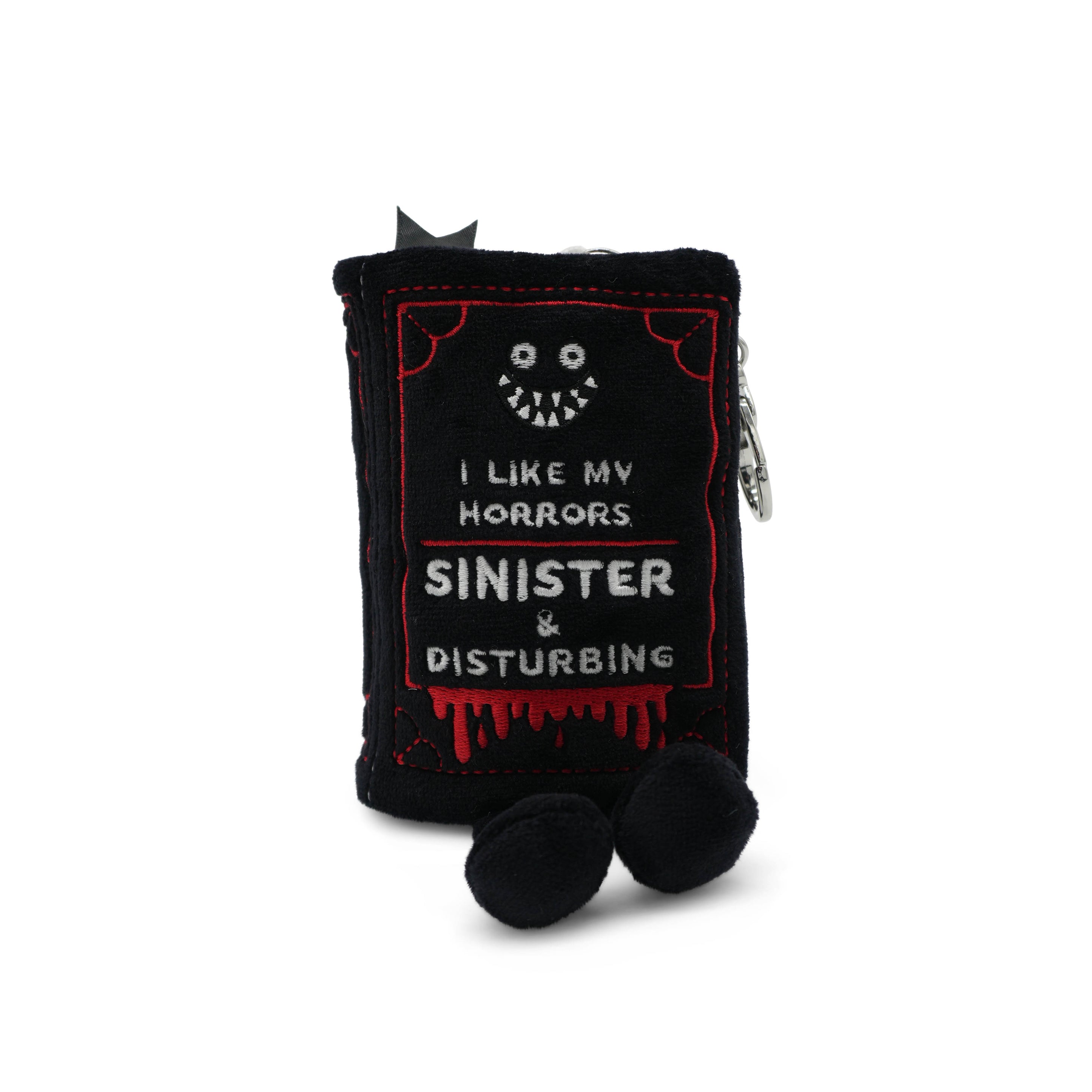 Black plush book bag charm with 'I like my horrors sinister & disturbing' text.