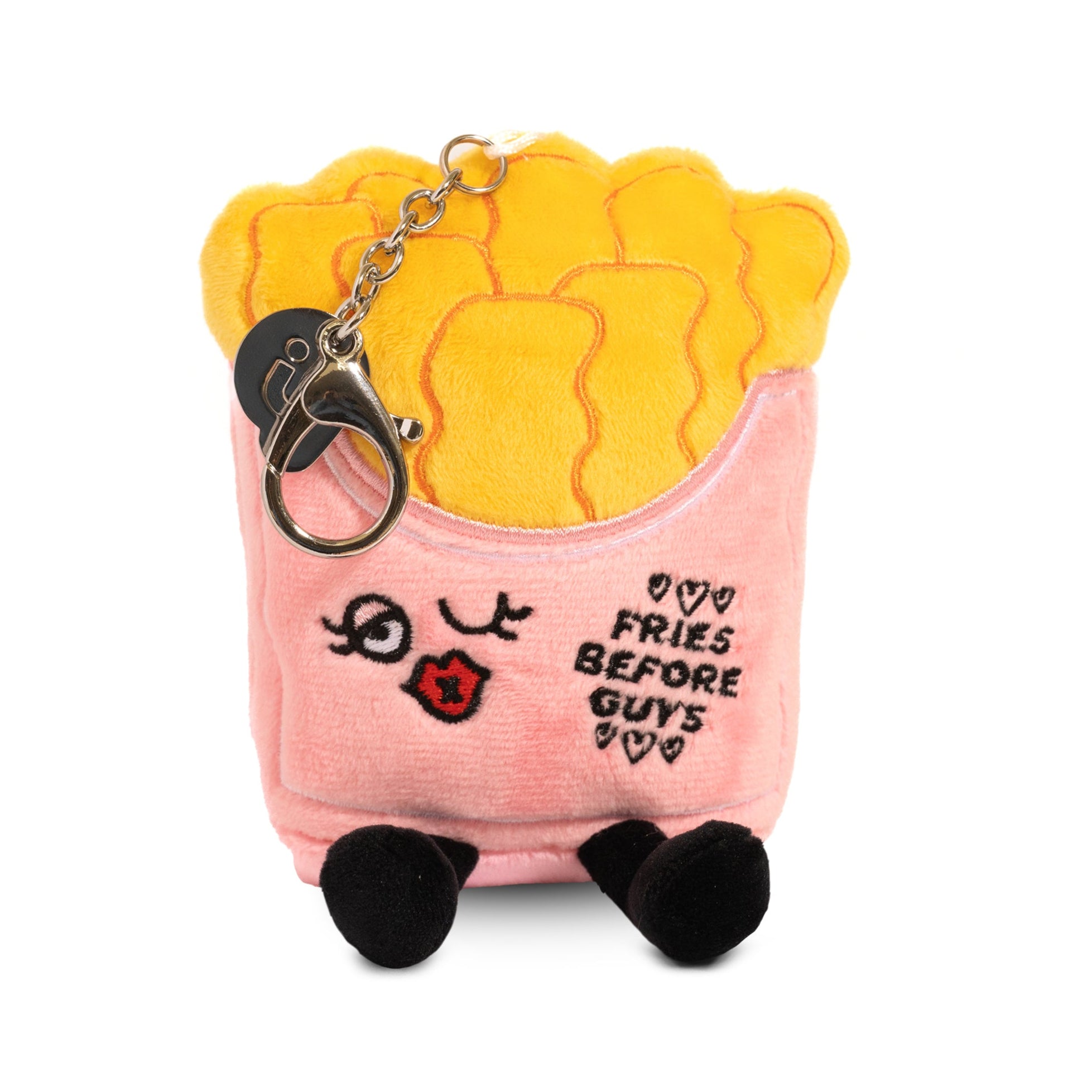 A plush bag charm designed to look like a carton of French fries with eyes and the text 'Fries Before Guys'.