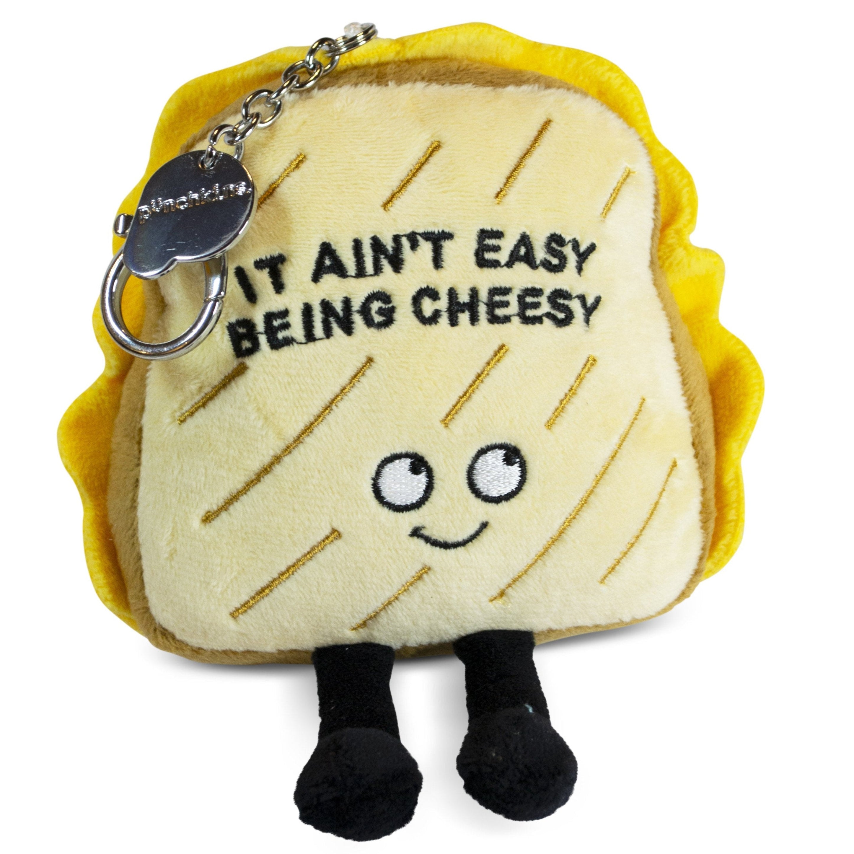 A plush charm designed to look like a grilled cheese sandwich with the phrase 'It Ain't Easy Being Cheesy' written on it, featuring a smiling face, dangly legs, and 3D grill marks.