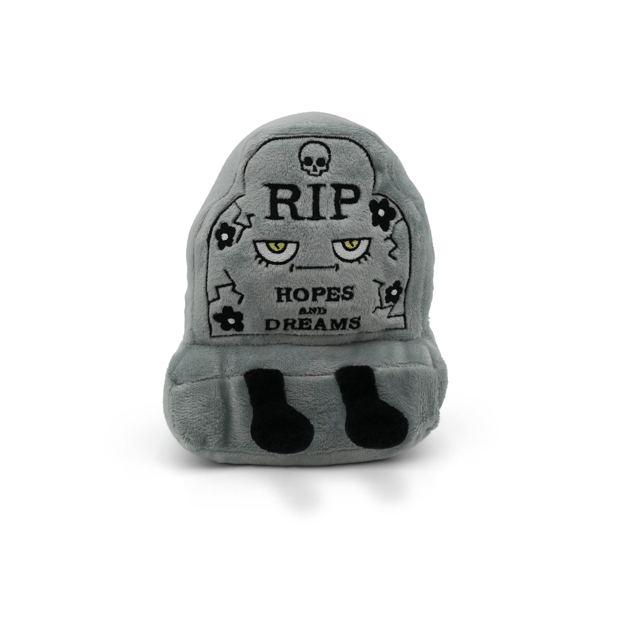 Gray plush toy shaped like a headstone with text and skull designs on a white background.