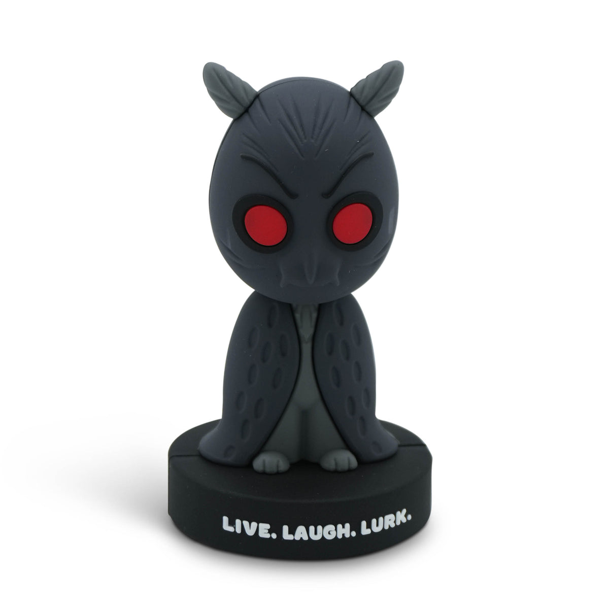 A figurine of the Mothman with red eyes, sitting on a black base printed with the words 'LIVE. LAUGH. LURK.'