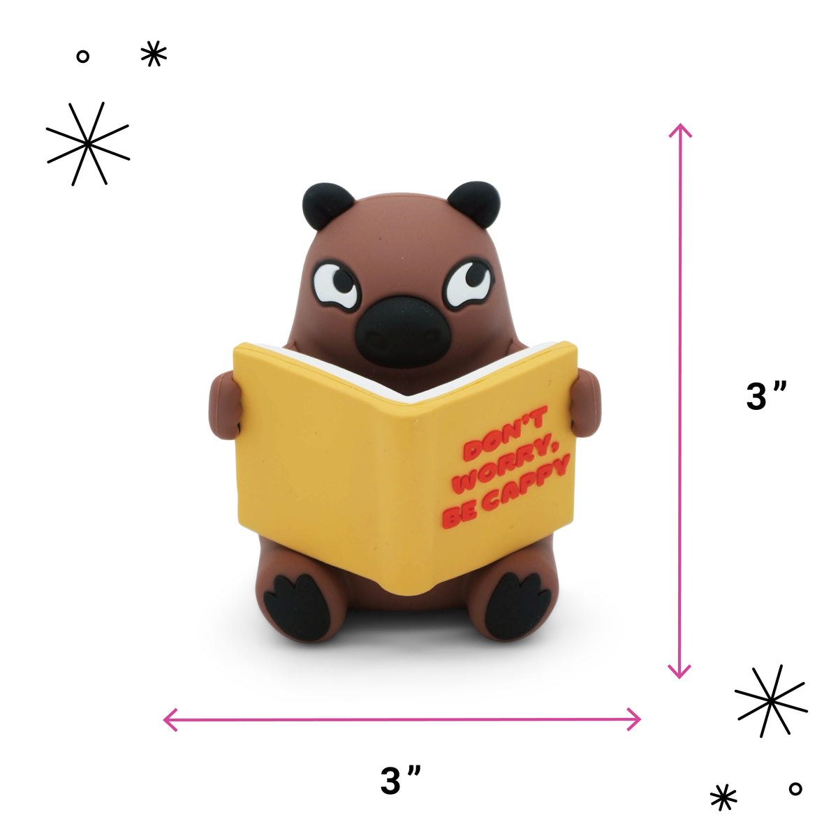 A small brown cartoon capybara holding a yellow book with red text reading 'DON'T WORRY, BE CAPPY' on a white background, with pink dimension arrows and '3"' labels indicating the product's height and width.