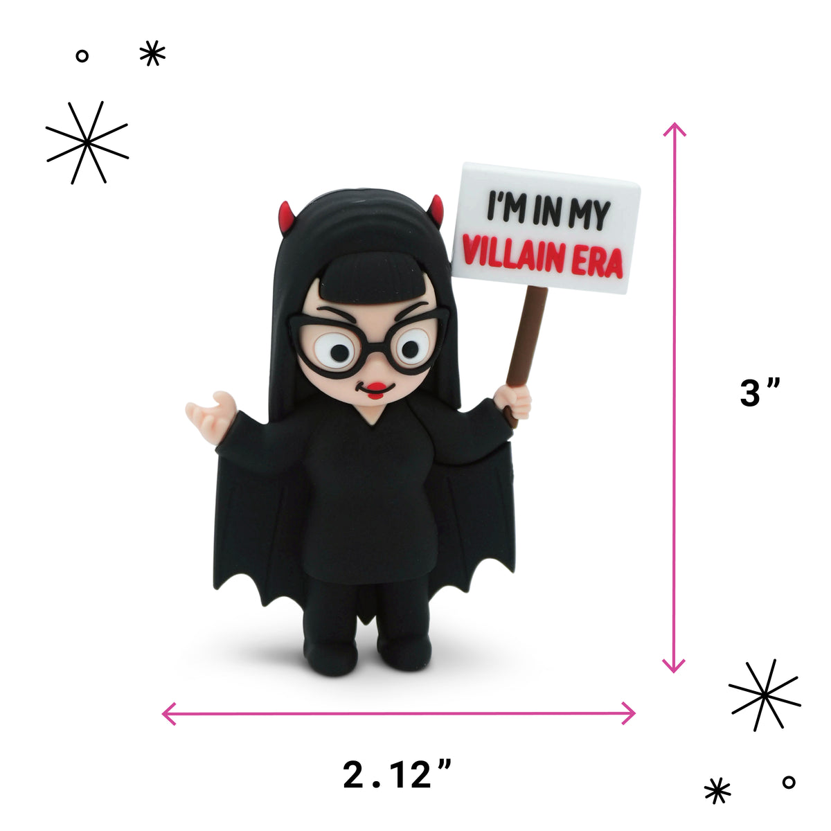 A small black devil-costume figurine holding a sign that reads “I’M IN MY VILLAIN ERA,” shown on a white background with pink dimension arrows indicating 3 inches tall by 2.12 inches wide.