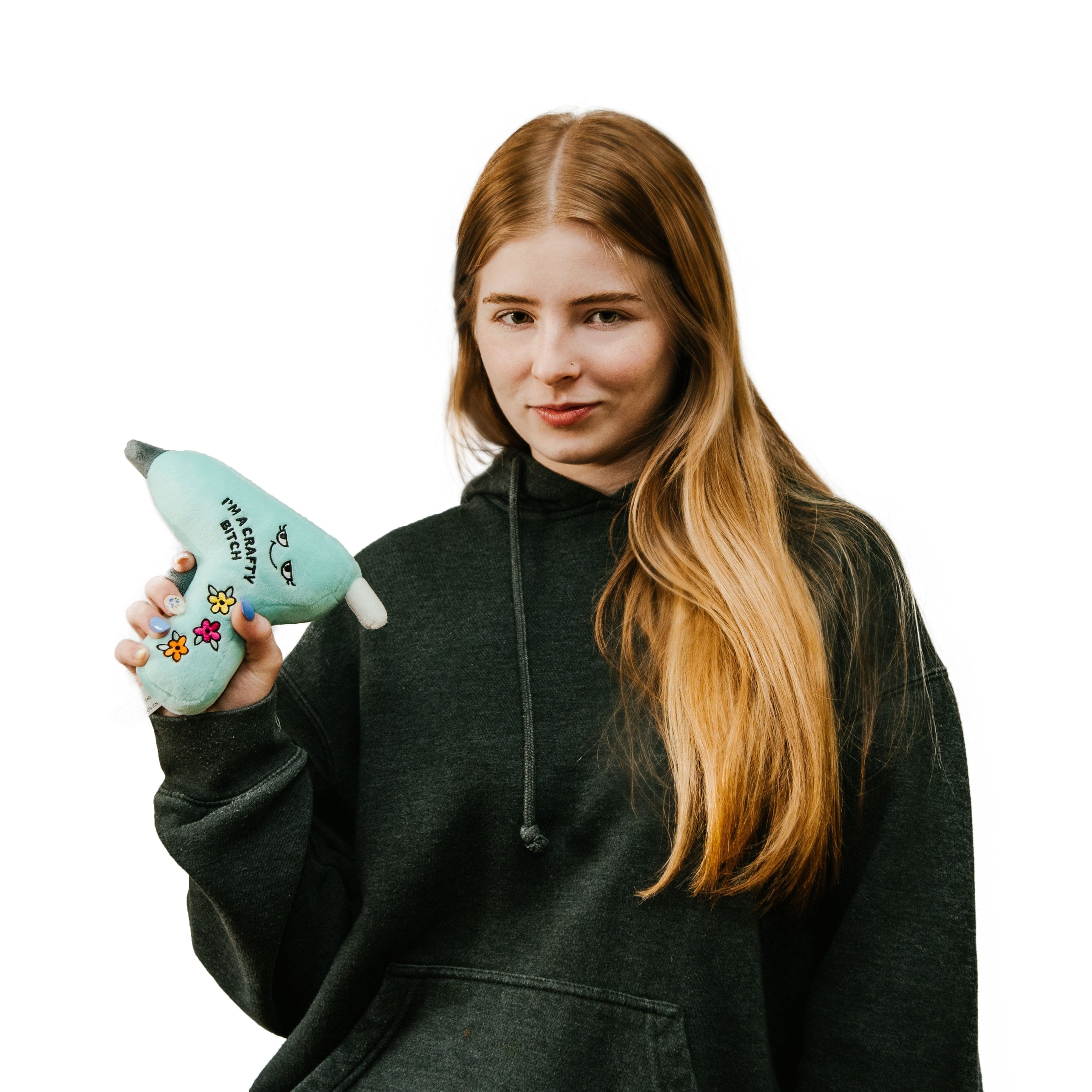 A model holding a plushie shaped like a glue gun displaying the text 'I'M A CRAFTY BITCH' on the side.