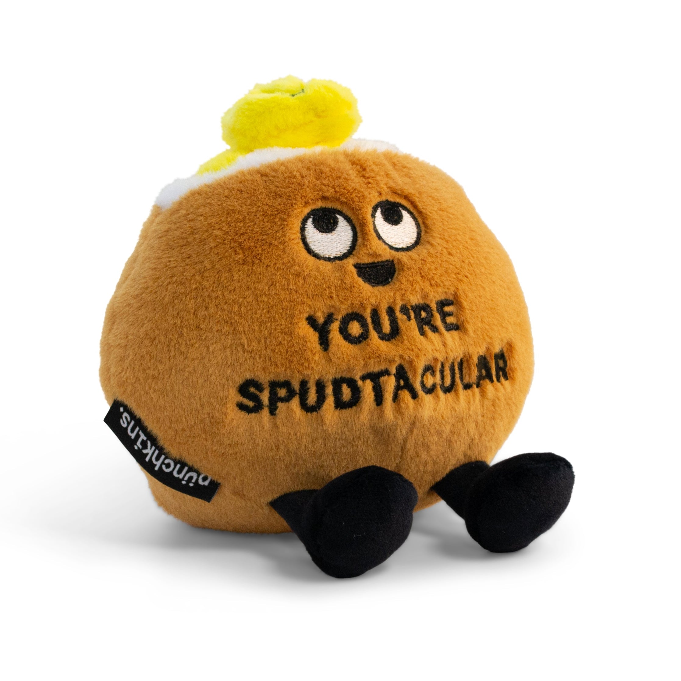 A plush designed to look like a potato with a smiling face, dangly legs, and a piece of butter on top. It has the text 'YOU'RE SPUDTACULAR' printed on its body.