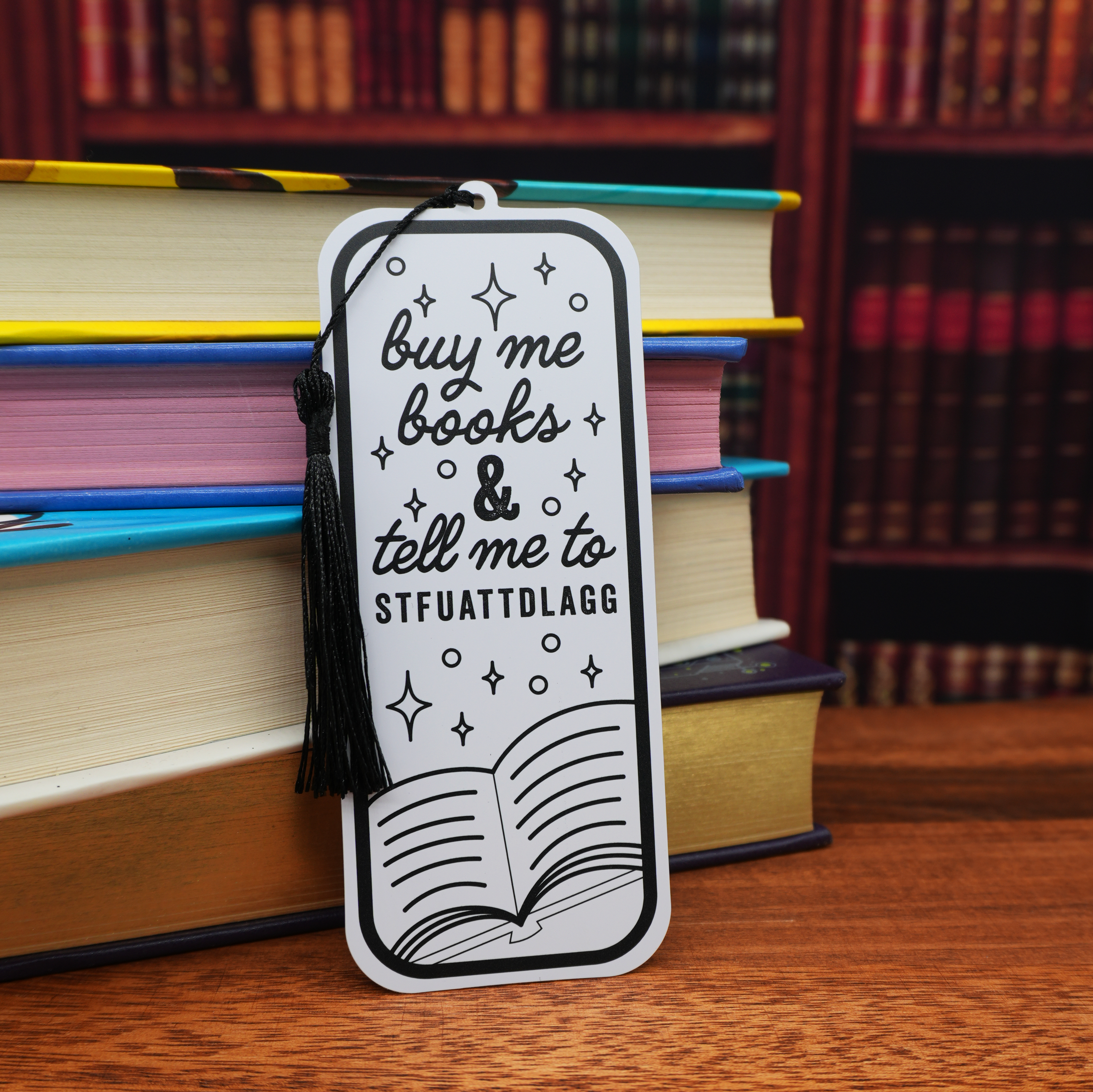 Bookmark with funny text on a wooden surface with books in the background