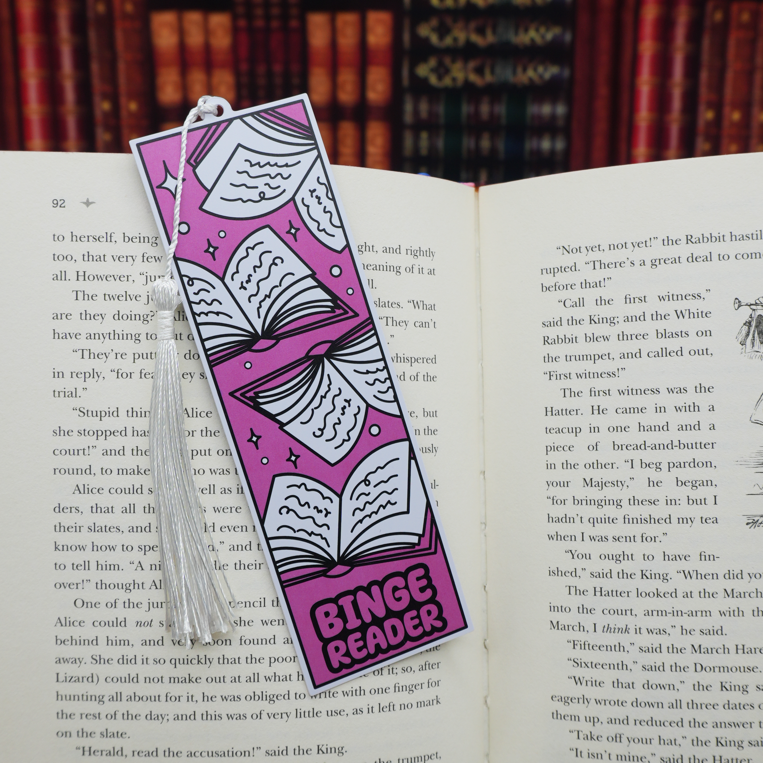 Pink and white patterned bookmark with 'Binge Reader' text on an open book