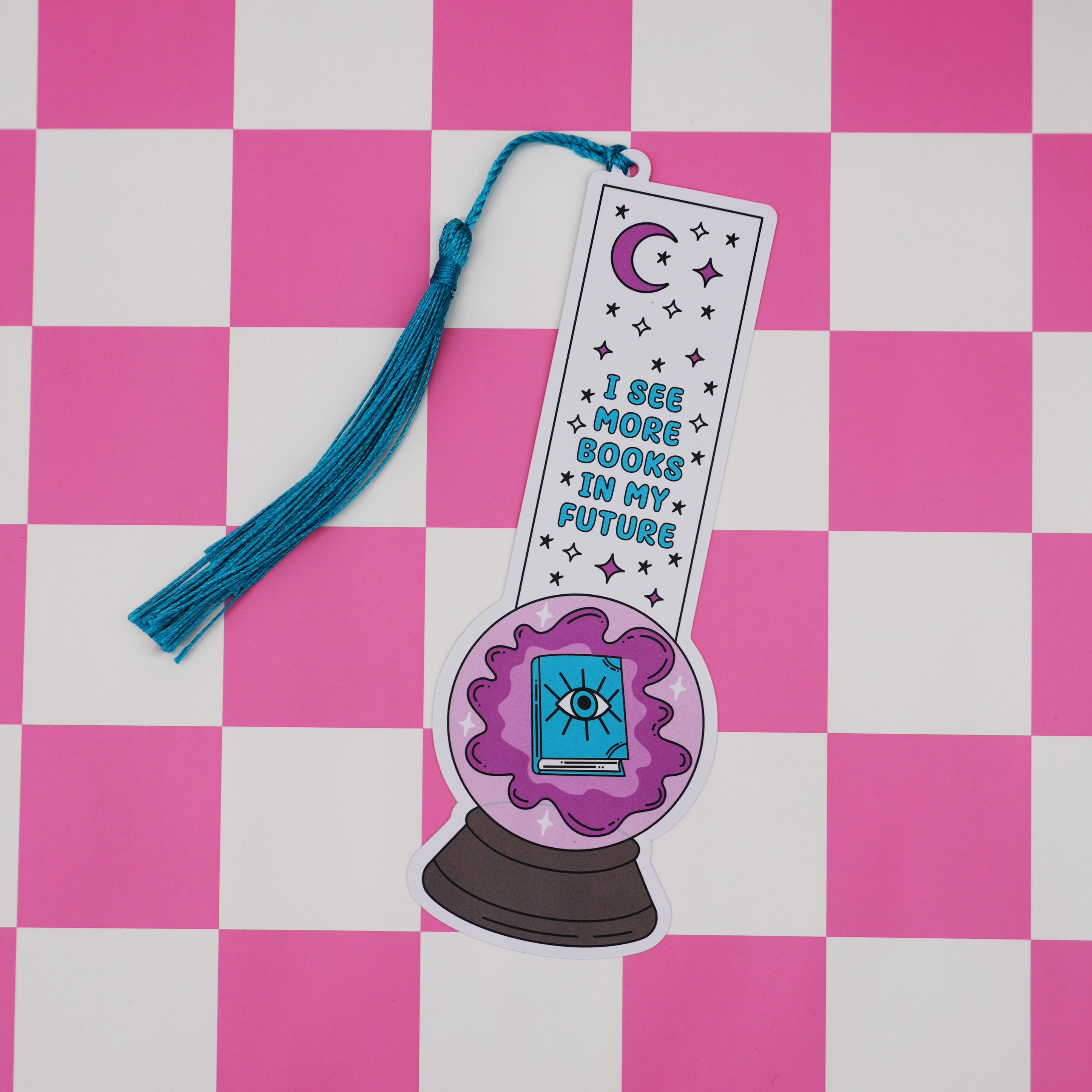 Bookmark with a crystal ball design and text on a pink and white checkered background