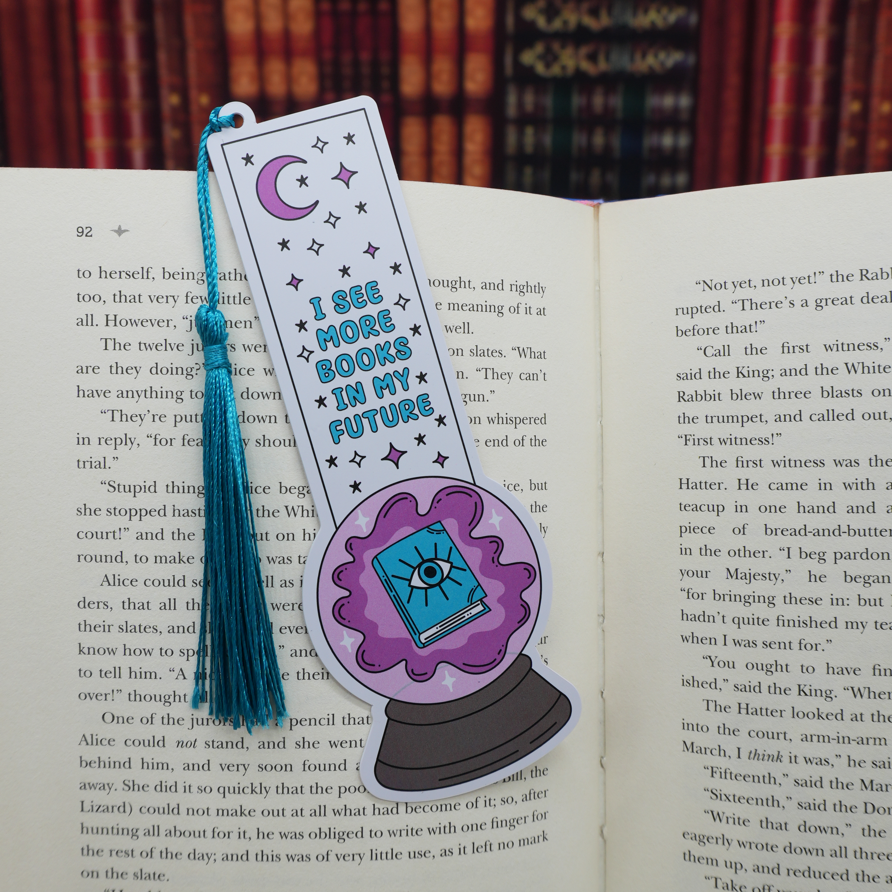 Bookmark with a purple crystal ball design and text on an open book