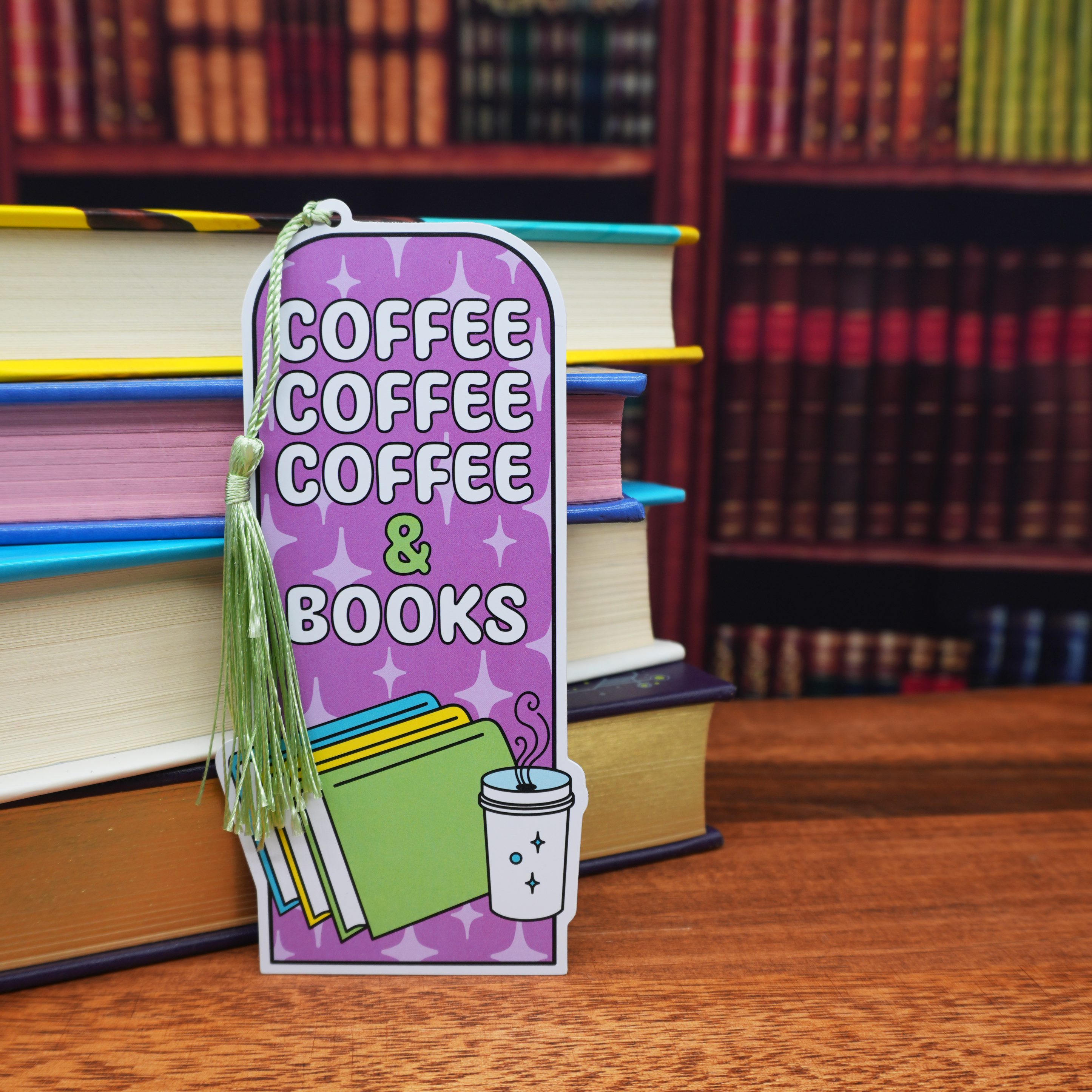 Bookmark with 'Coffee Coffee Coffee & Books' text and coffee cup graphic on a stack of books.