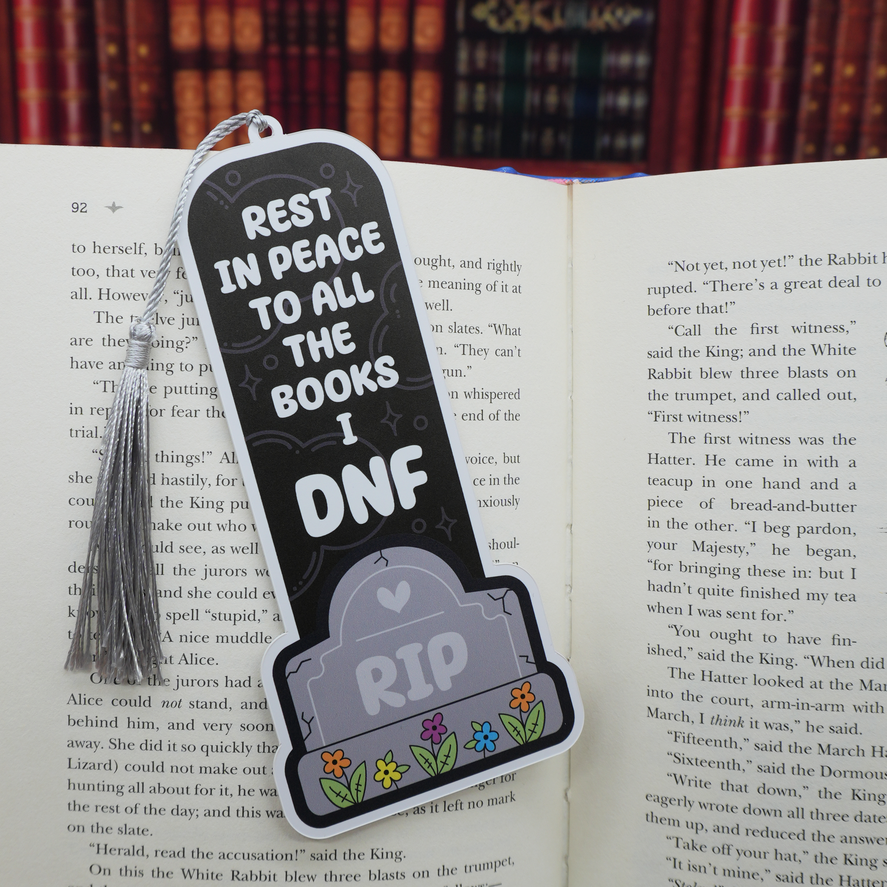 Bookmark with 'Rest in Peace to all the books I DNF' text on an open book.