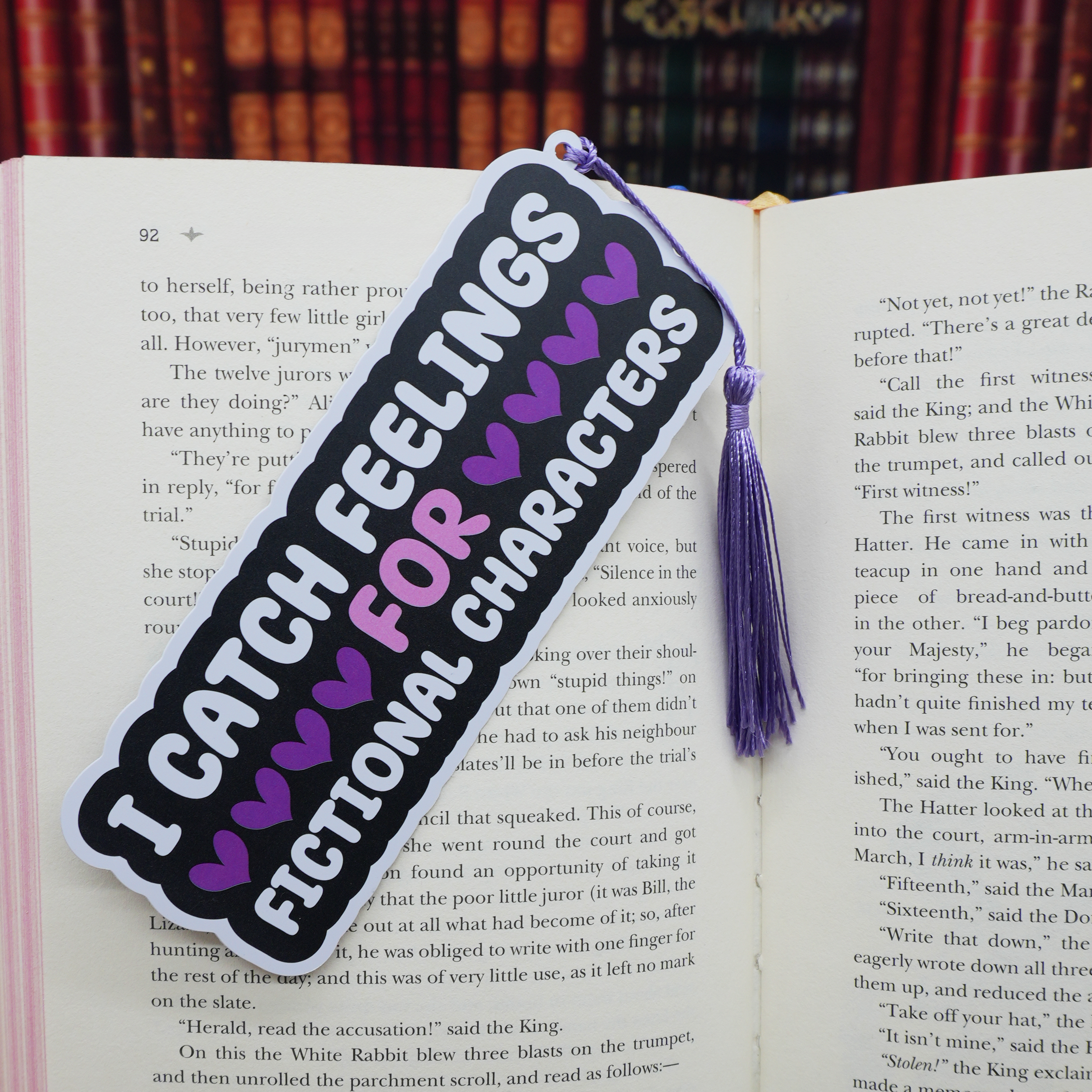 Bookmark with text 'I catch feelings for fictional characters' on an open book