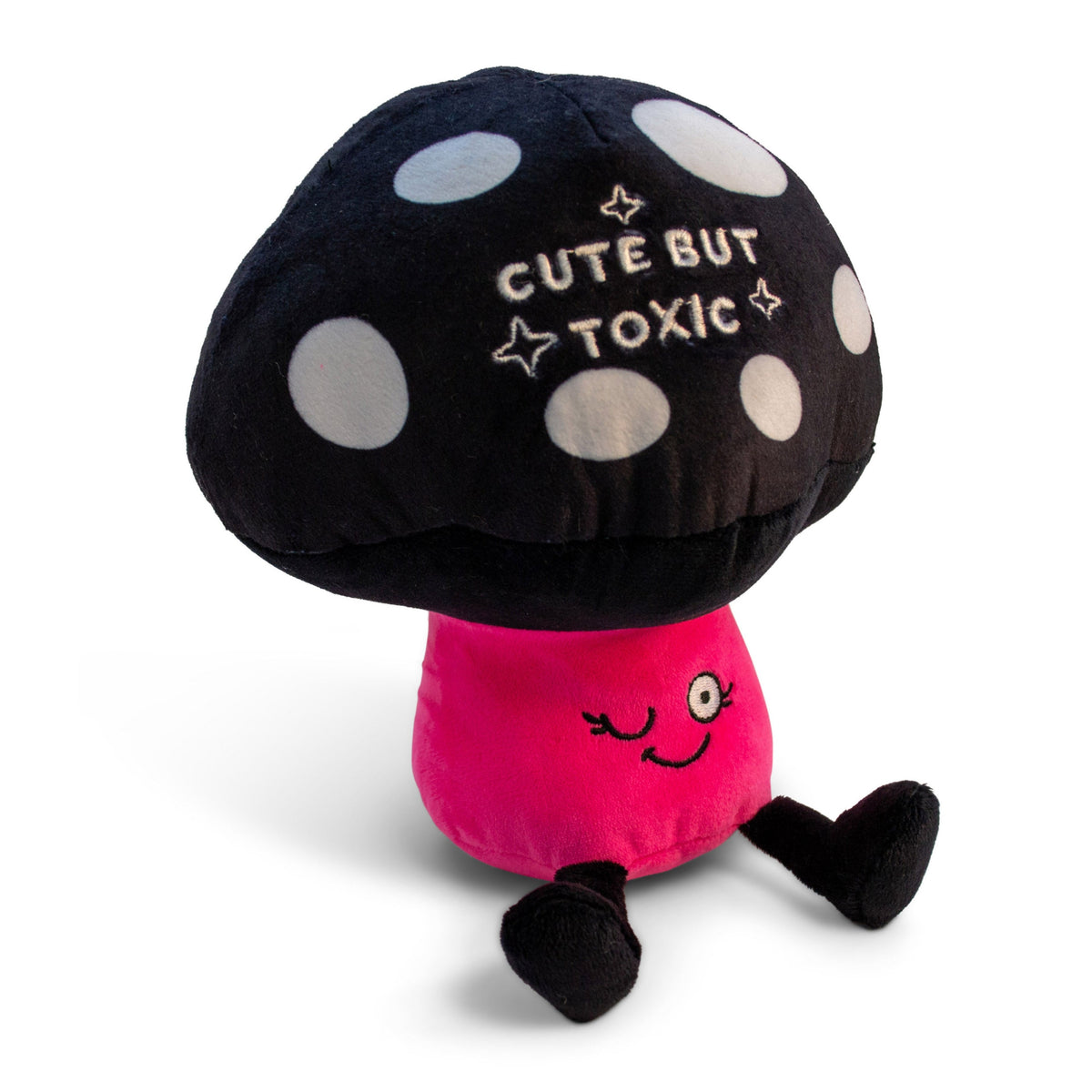 A plush resembling a mushroom with a black cap and pink stem, with the text 'CUTE BUT TOXIC' written on the cap.