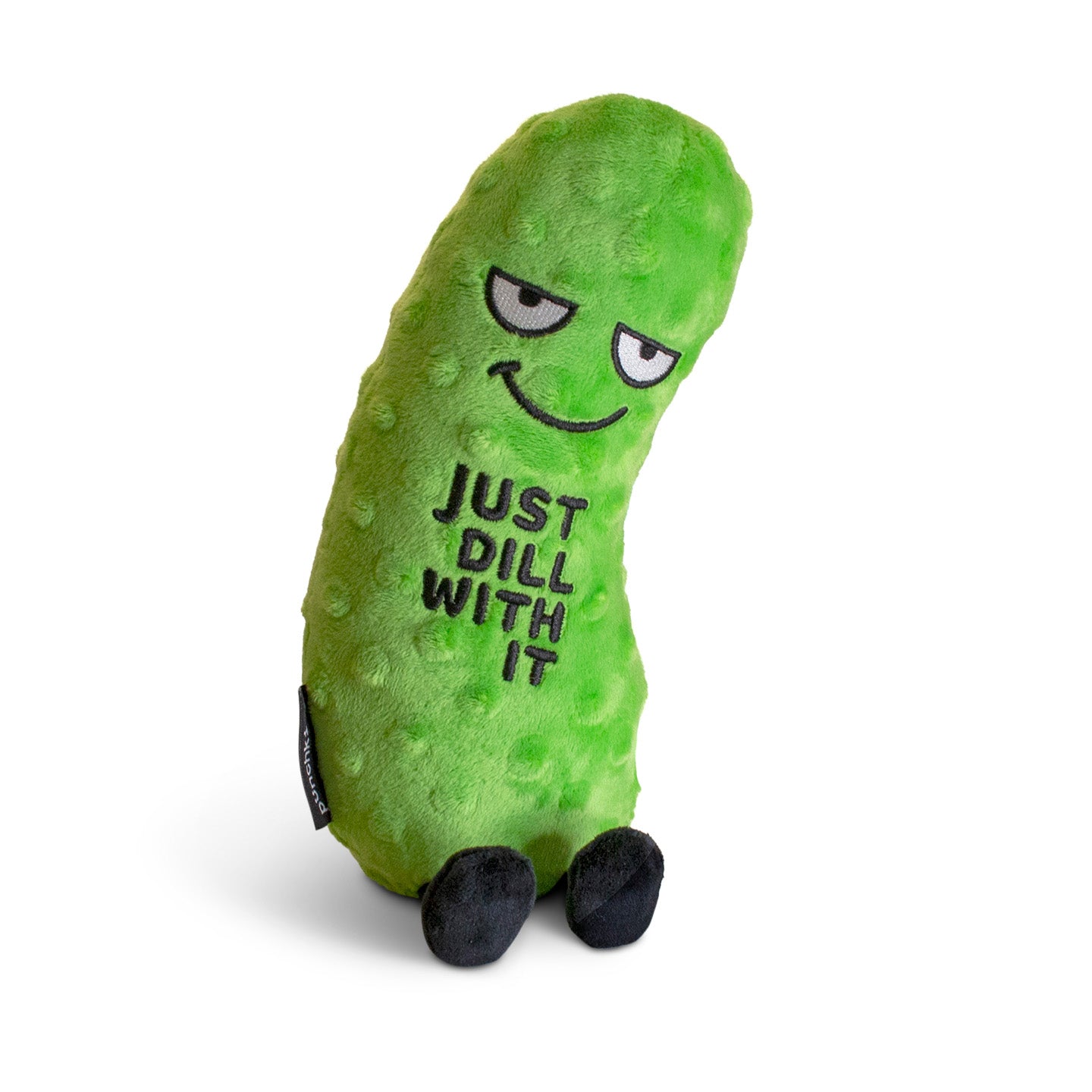 A plush shaped like a pickle with a smiling face and the phrase 'JUST DILL WITH IT' printed on its surface.