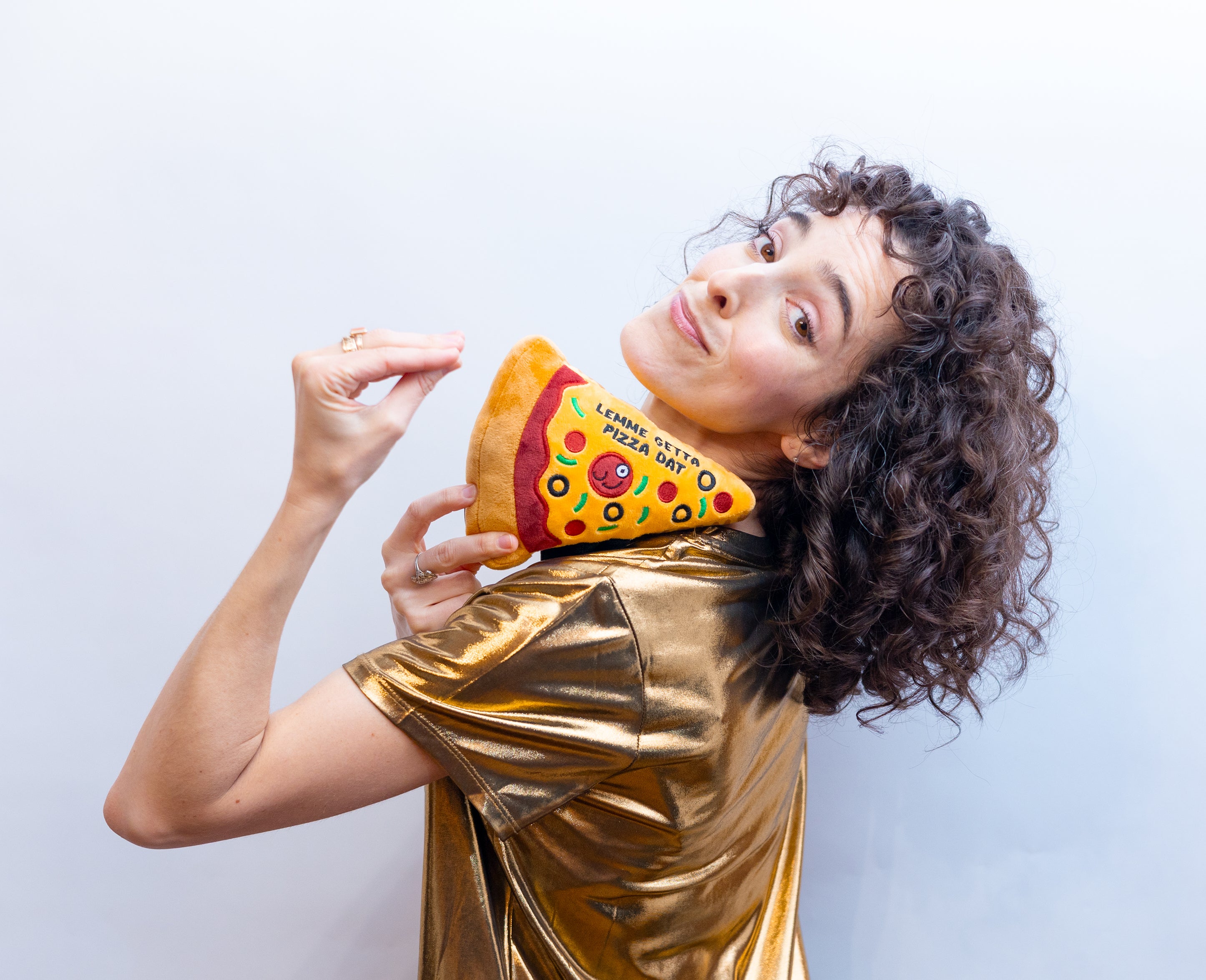 A woman holding a plush shaped like a slice of pizza with the text 'Lemme get a pizza dat' written on it.